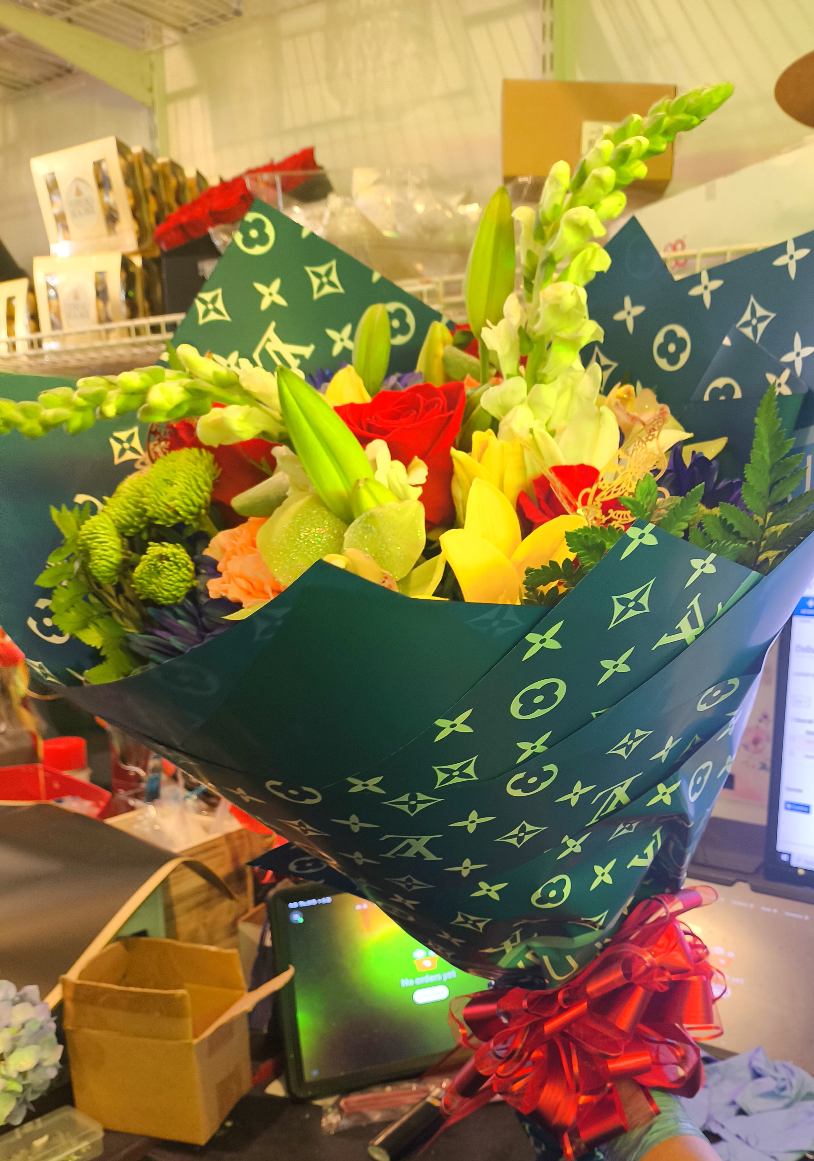 Large mixed colorful bouquet  - Here is a nice colorful bouquet wrapped in designer paper with a big red bow.
