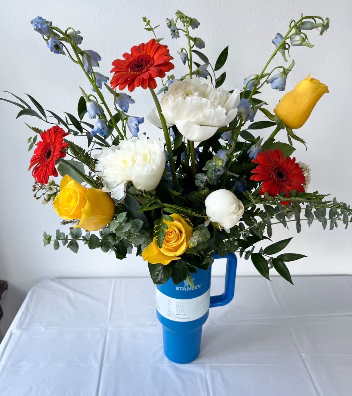 Stunning Stanley! - WOW!  40oz Stanley brand tumbler filled with the freshest seasonal blooms including hydrangea, roses, lilies, sunflowers, solidago.  *LIMITED AVAILABILITY, put your top 2 or 3 tumbler color choices in comments or call the shop to confirm current availability.   We most commonly carry Ivory, blush, hot pink, black, charcoal, pool blue and moss green.  
