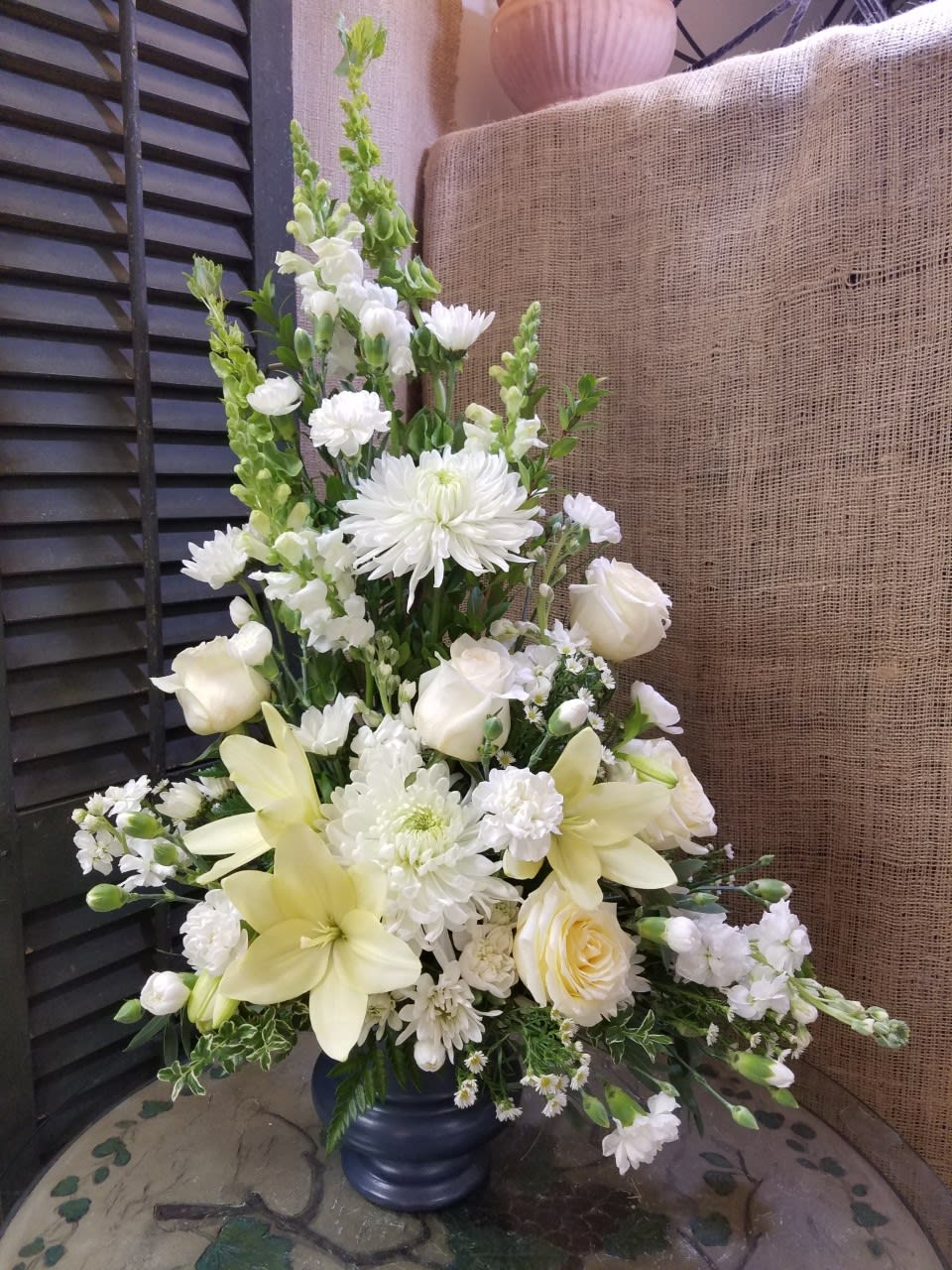 Simple Elegance  - Stunning arrangement in a pedestal container featuring gorgeous white flowers of all kinds. Simple and Elegant! 