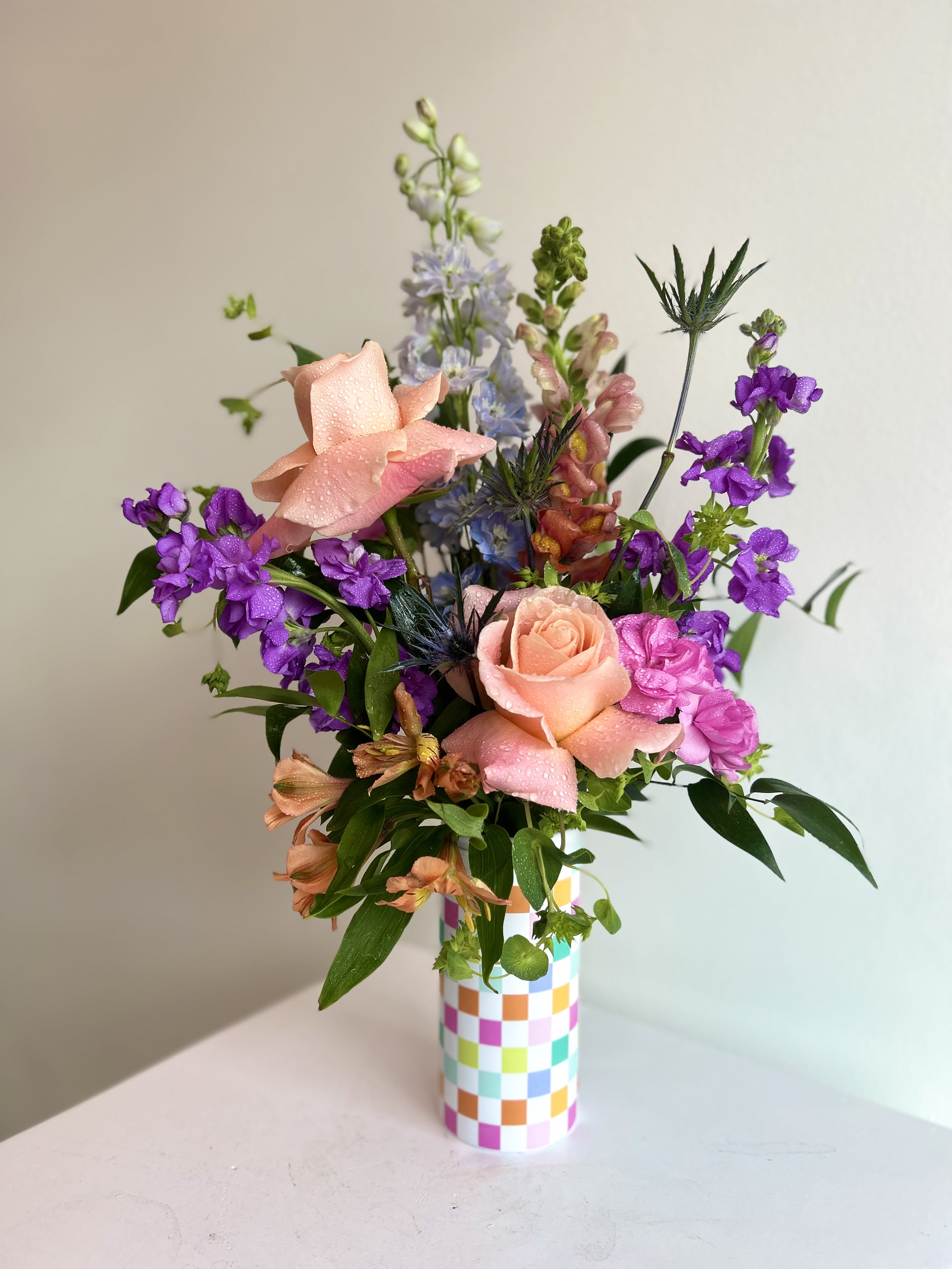 Bloomzie - Bursting with vibrant seasonal blooms and tucked inside a cozy koozie, this arrangement brings a splash of color with personality to match it. Thoughtfully arranged inside an insulated drink sleeve, making it both eye-catching and delightfully unconventional. It’s charming, unexpected, and perfectly chilled for any celebration or sunny day surprise. 