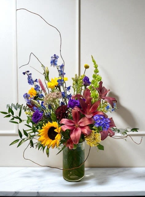 Velvet Sunset - A rich and vibrant arrangement featuring bold tones of burgundy, golden yellow, and deep purple. Designed in a natural, garden-inspired style, this piece captures the warmth and drama of a sunset—luxurious, colorful, and full of life. A striking choice for any occasion that calls for beauty and depth.