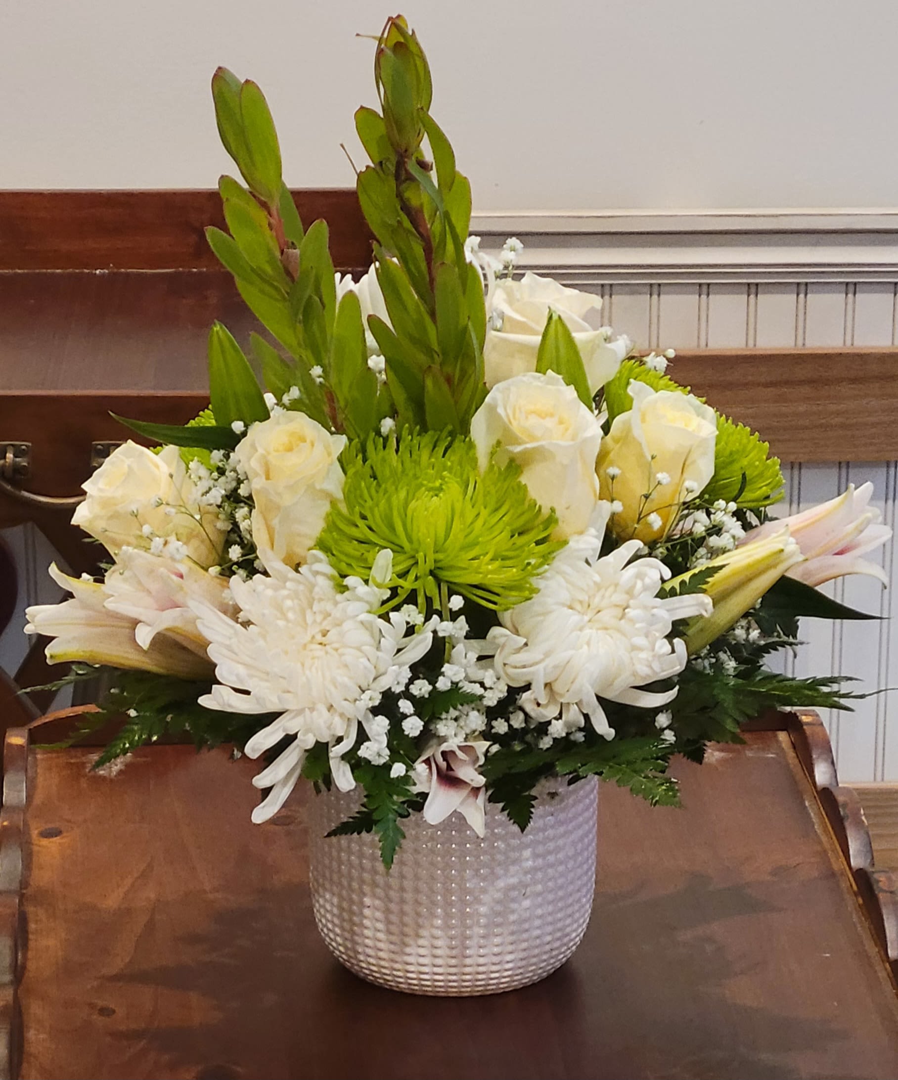 Peaceful Elegance by Dixie's Flowers - &quot;Soft and elegant, this all-white and green mix features roses, mums, lilies, and fresh greenery—designed in a textured white vase for a timeless and calming look.&quot;