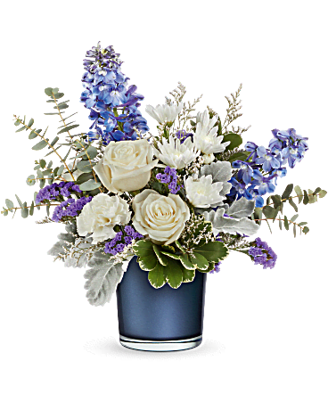 Sapphire Bliss Sapphire Bliss - Experience tranquility with our exquisite crème rose bouquet, reminiscent of fluffy white clouds drifting against a pristine blue sky. This stunning arrangement is elegantly complemented by a sapphire blue glass vase that sparkles with a mesmerizing pearlescent finish. Elevate your space and captivate your senses with this stunning combination. Enjoy the convenience of same-day delivery from your local flower shop in Ajax, Pickering, and Oshawa.