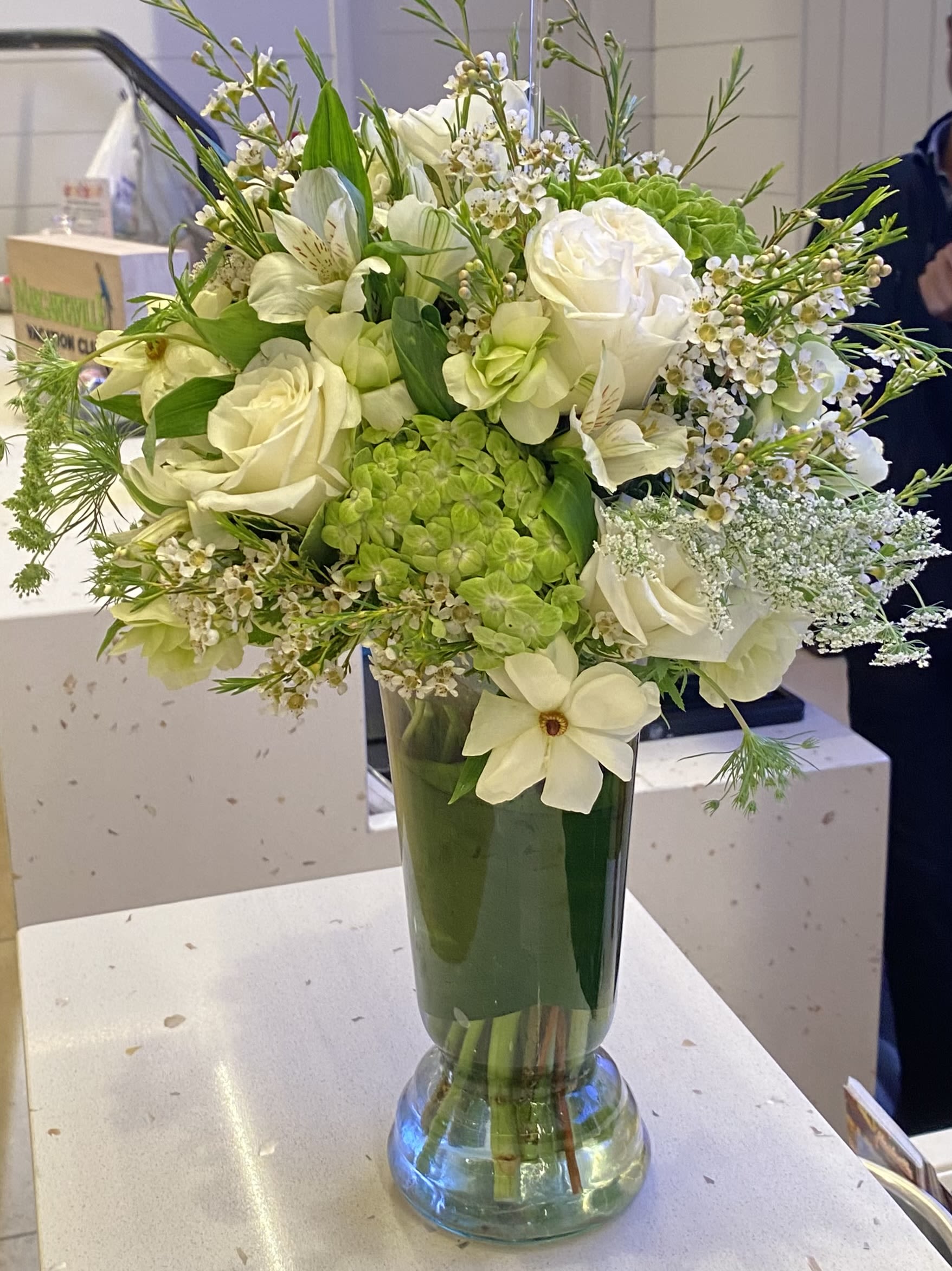 Sophia's Serene Dreams - An elegant and classic arrangement of shades of white and green hydrangeas, ranunculus, and roses would be perfect for any occasion. 