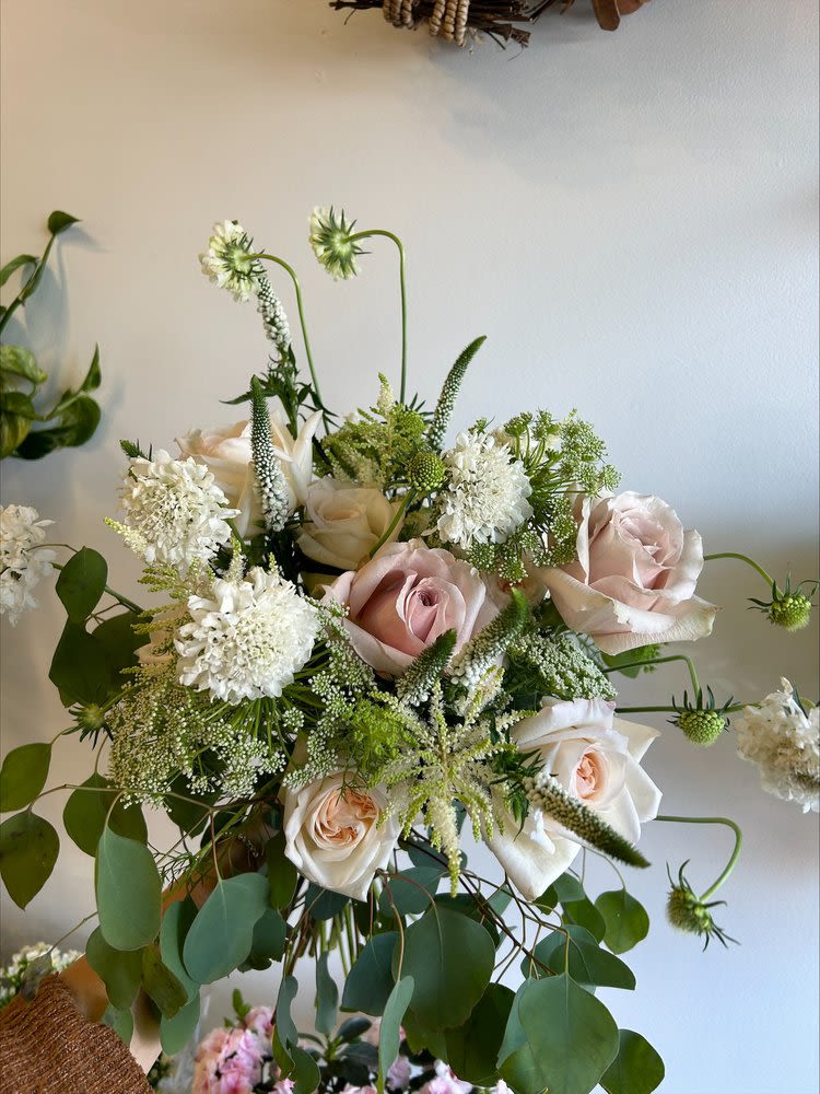Summer 27 - A hand tied bouquet with pastel-garden-inspired flowers  Due to the availability of certain flowers, substitutions might occasionally be necessary to assemble your bouquet. 