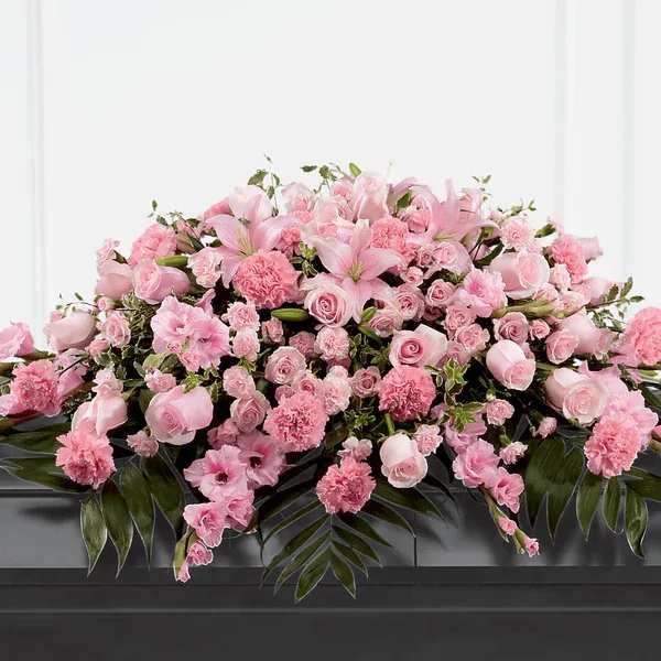Garden of Comfort Casket Spray - Honor a loved one who was sweet, compassionate and charming with our Garden of Comfort Casket Spray. It is crafted with care and composed of a refined array of pink lilies, gladiolus, roses, carnations and accents of luscious greens. This arrangement is a touching tribute that beautifully expresses your love.