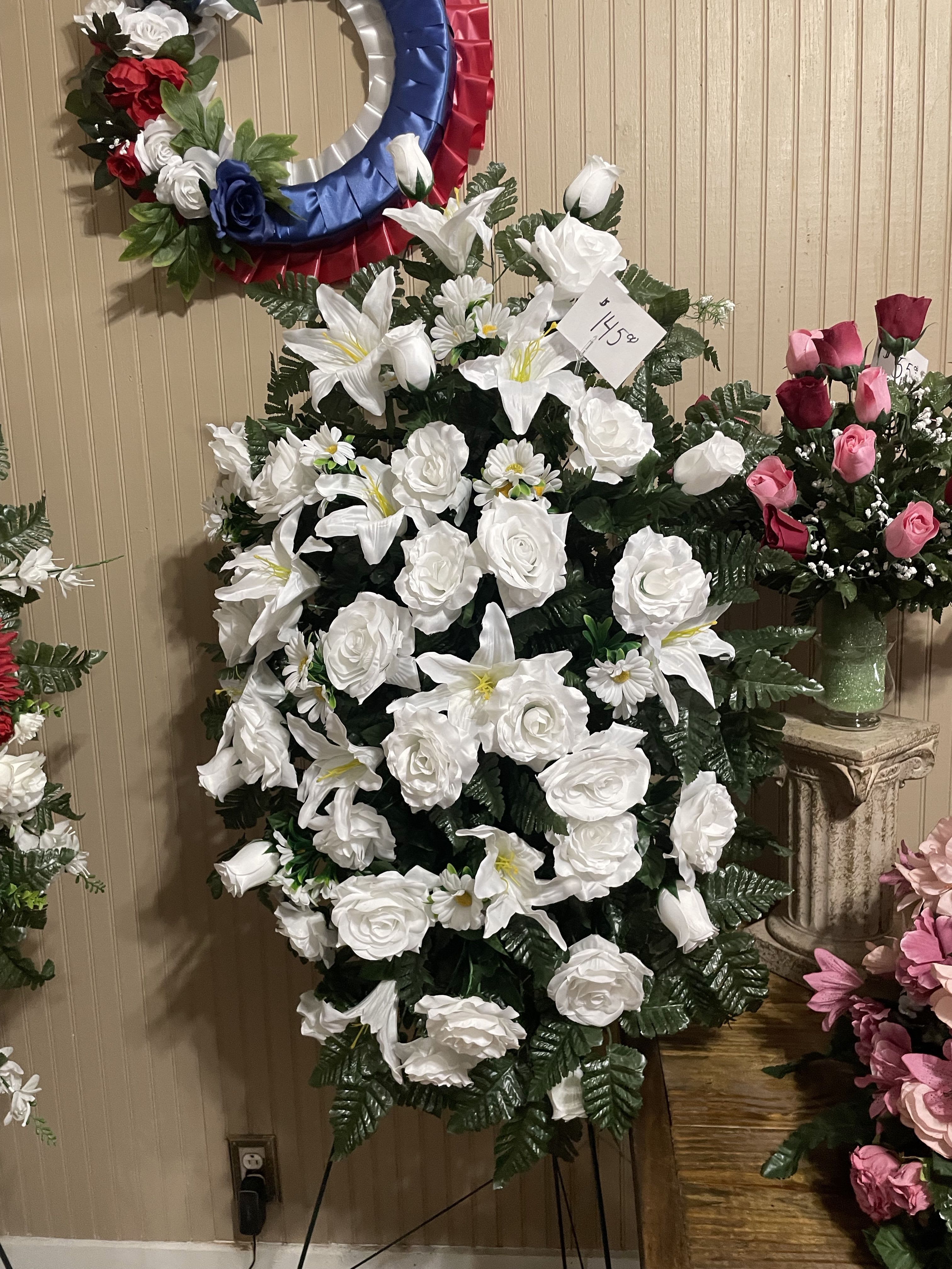 White Silk Spray White Silk Spray - When someone so dear passes, it is fitting to pay respects with a standing tribute. Our impressive standing spray arrangement, creates a proud and respectful commemoration.