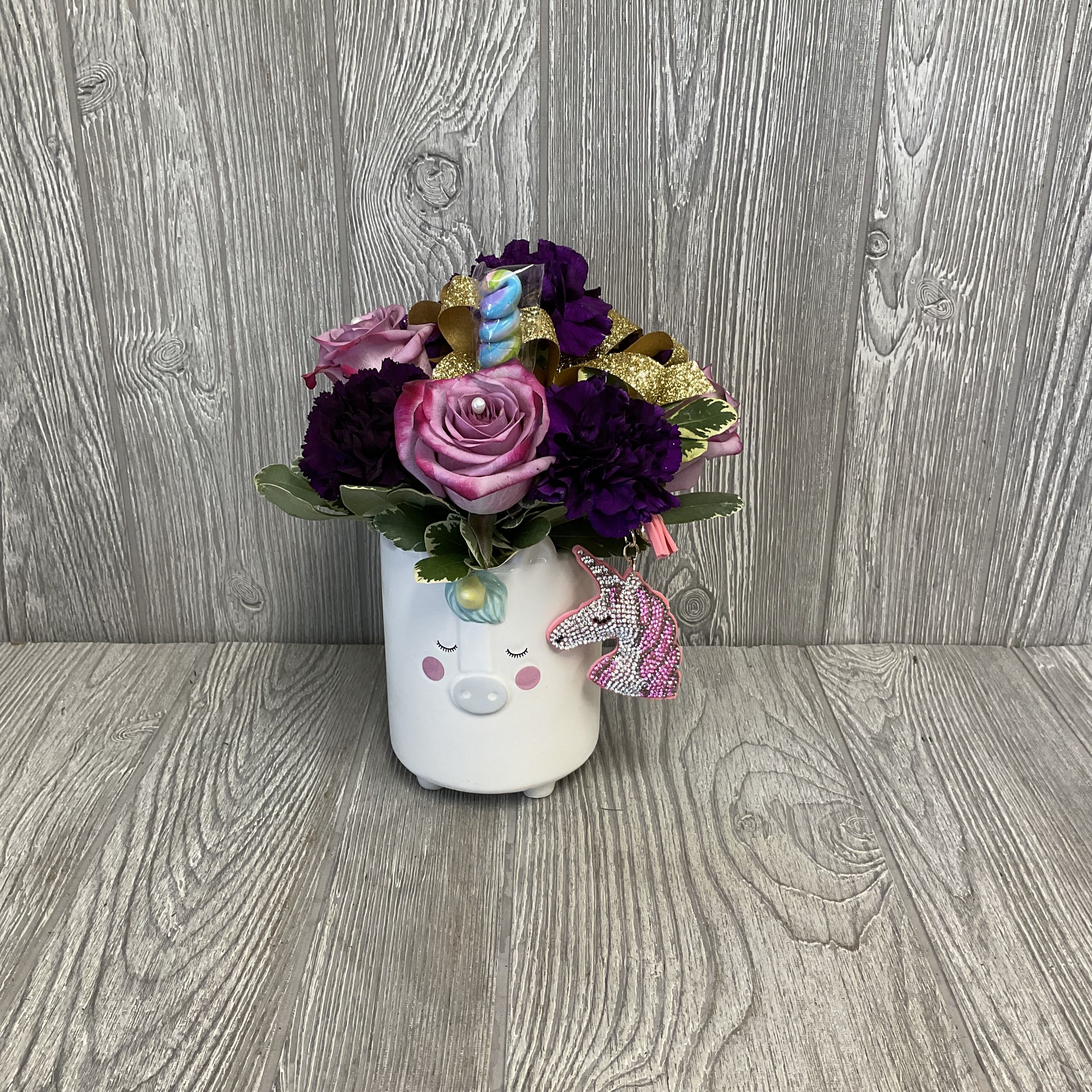 Lil Sparkles - A sweet and sparkly fresh cut flower arrangement. In a keepsake ceramic unicorn container with an edible lollipop and a rhinestone unicorn keychain. Great for your Delta Phi Epsilon daughters or daughters. Flowers may vary. 