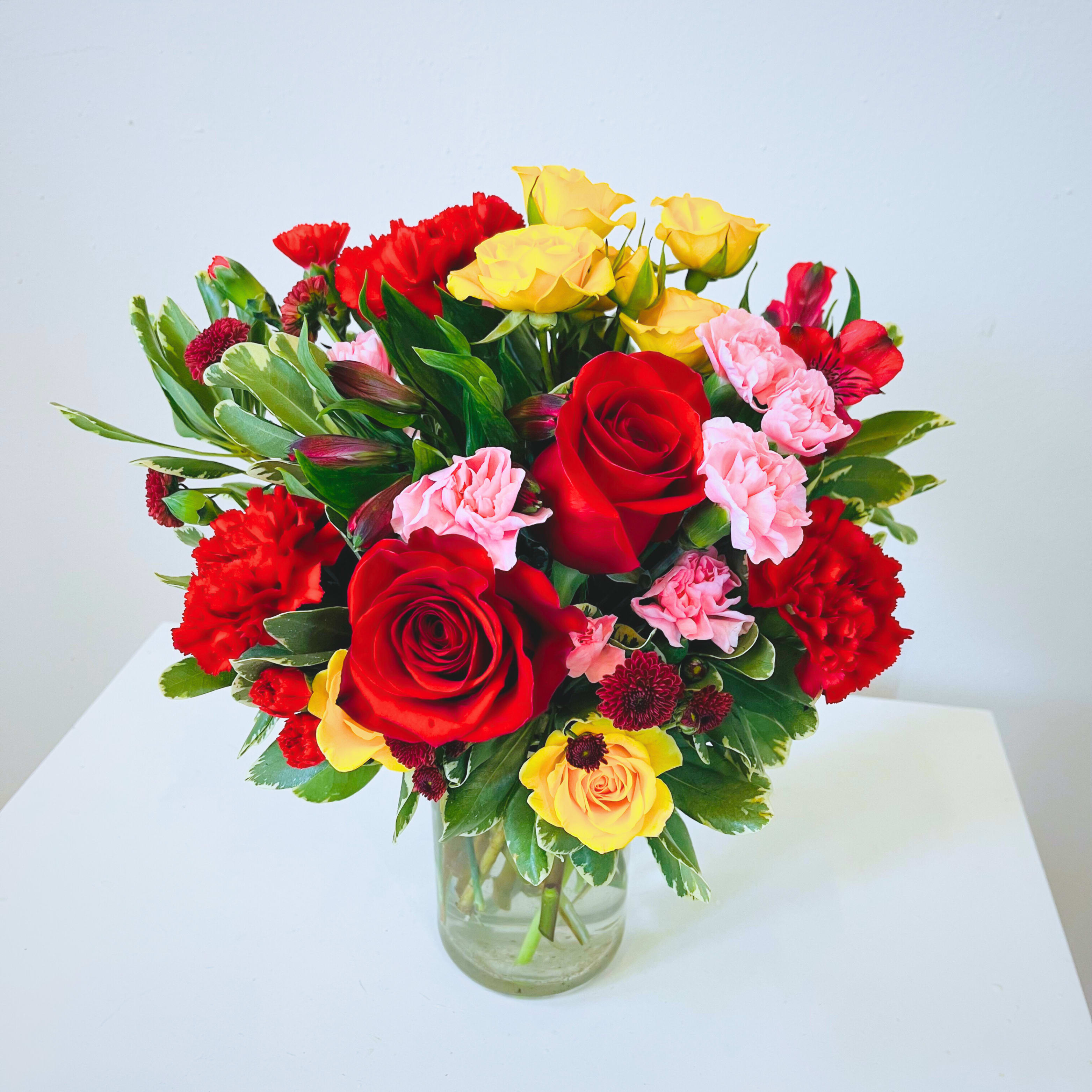 Vibrant Floral Mix - A lively mix of blooms in bold, bright colors, carefully arranged to bring joy and energy to any space. Perfect for birthdays, anniversaries, or any celebration, this vibrant bouquet is designed to stand out and create a lasting impression. Whether as a gift or a centerpiece, it’s a beautiful way to share happiness and warmth.