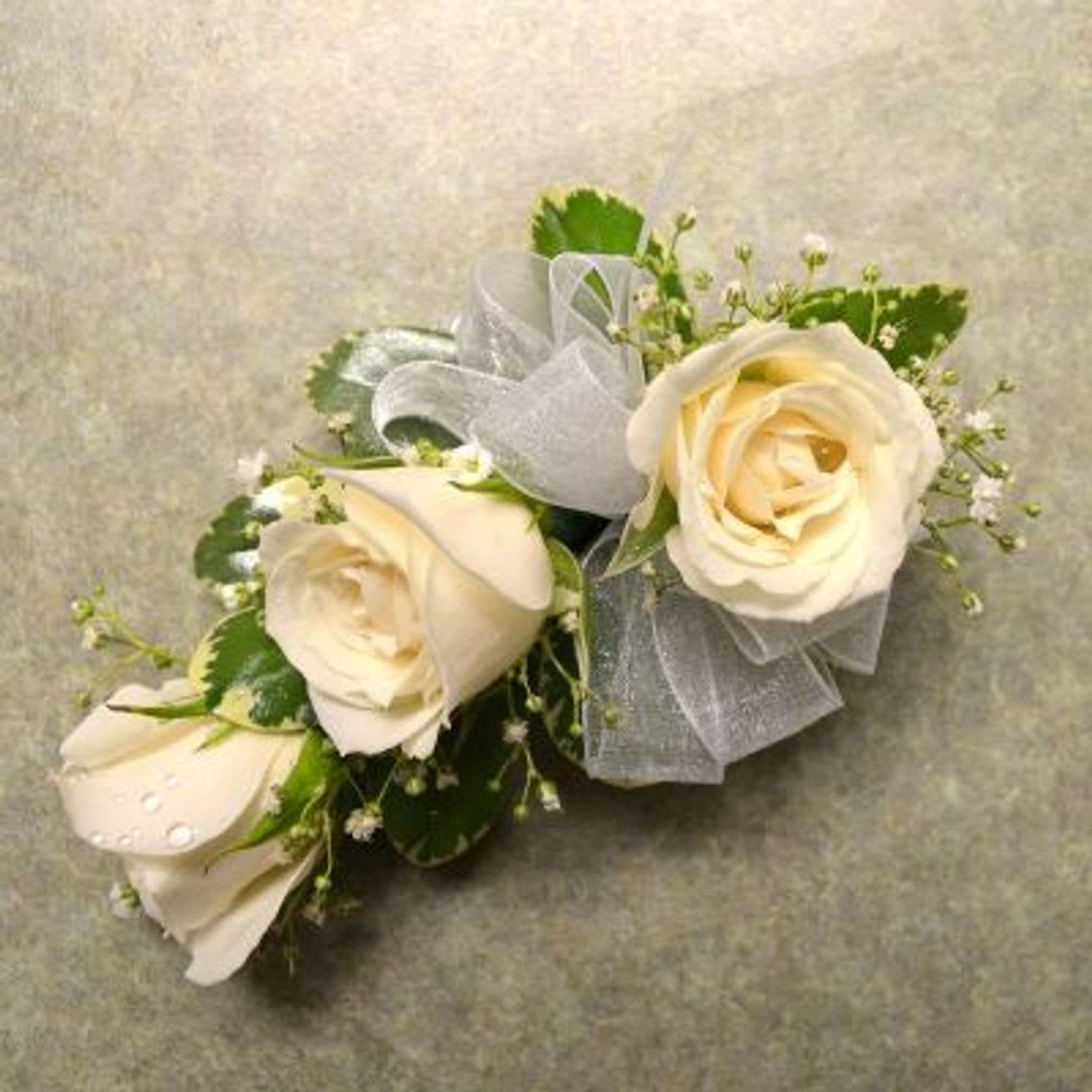 Corsage with 3 White spray Roses Corsage with 3 White spray Roses - Wrist corsage with three white spray roses, babies breath and white sheer ribbon.