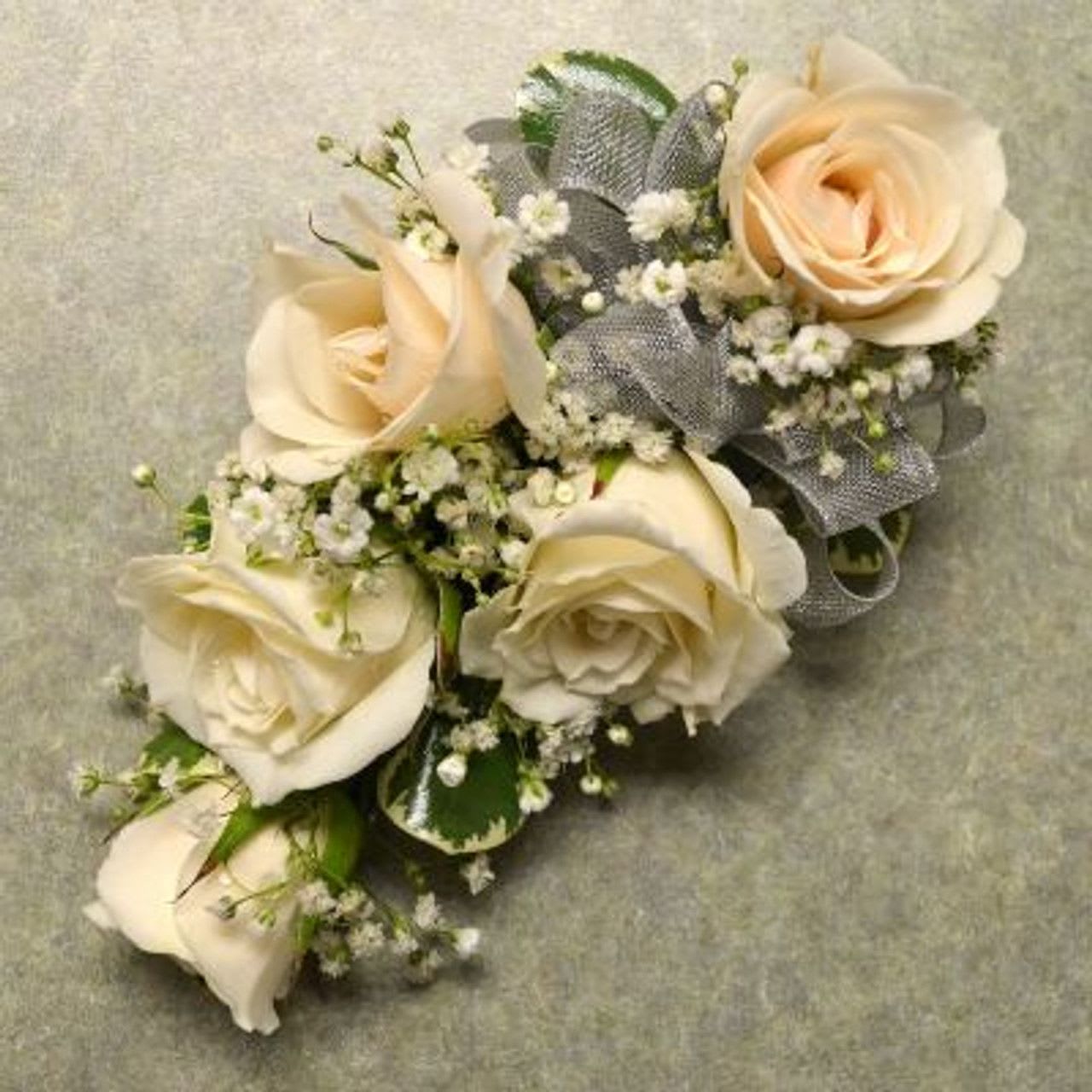 Corsage with 5 White Spray Roses Corsage with 5 White Spray Roses - Wrist corsage with five white spray roses, babies breath and silver ribbon.