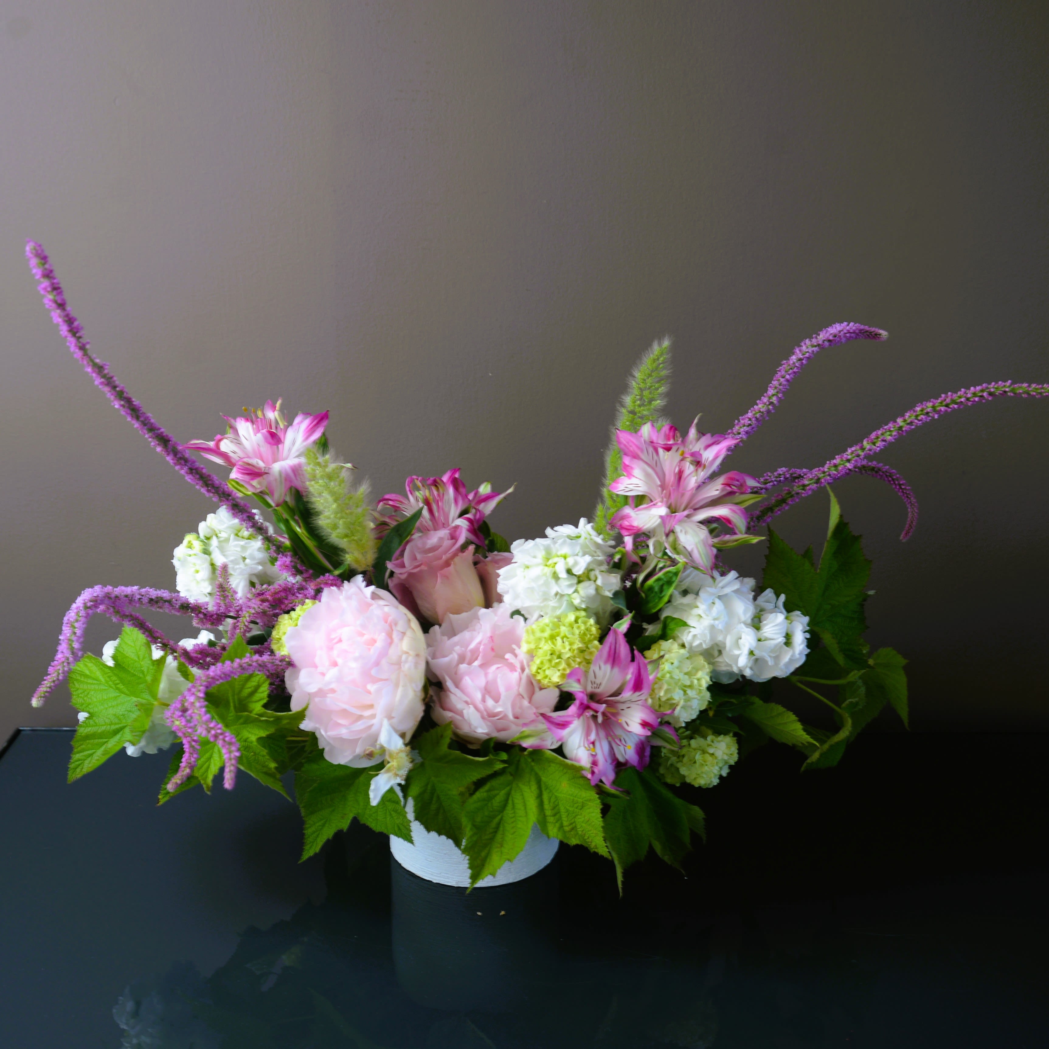 Seasonal Treasures Pastel - Our designers will select the most beautiful, seasonal blooms and greenery in pastel tones to create a beautiful arrangement. The standard size is perfect for a dining table for 4-6 guests or a larger coffee table.