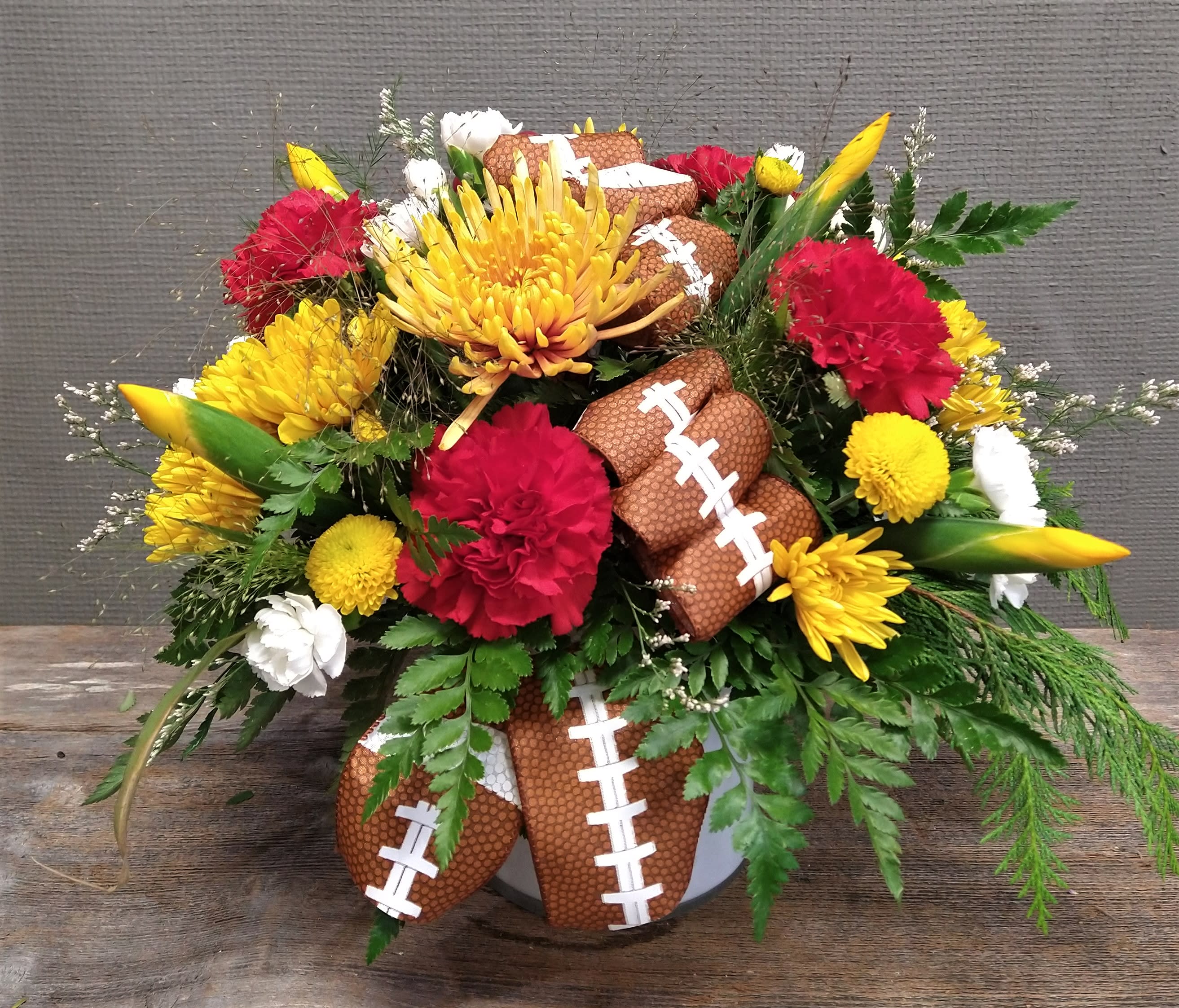 Tis the Season...for Football! - This football themed centerpiece can be personalized for whichever team you want. Pictured is for our Seahawk's fans. Just put the Team or the colors in special instructions, and we will customize the arrangement.
