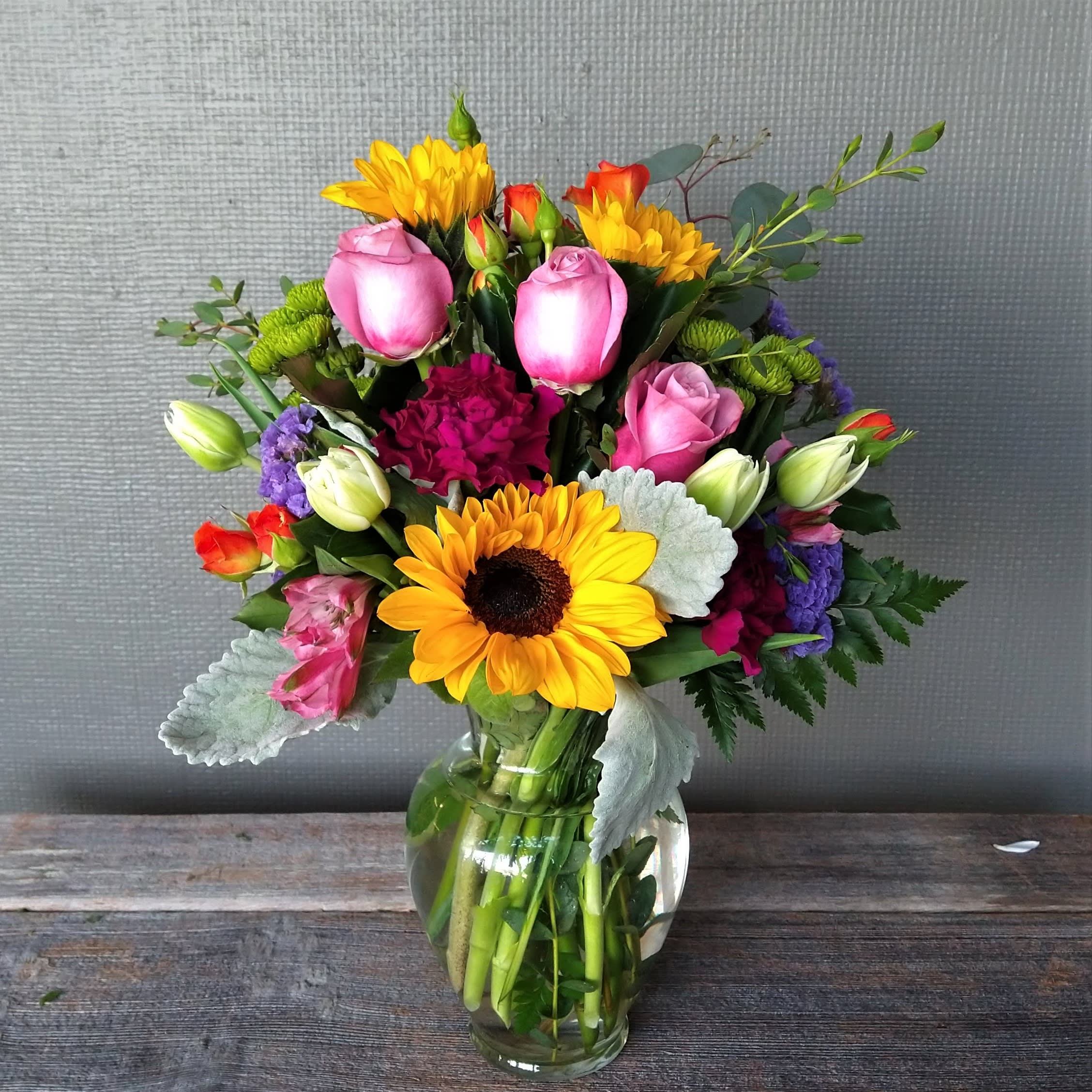 Here Comes the Sun...Flower - Sunflowers, roses, tulips, spray roses, carnations, and alstroemeria in all the bright colors. 