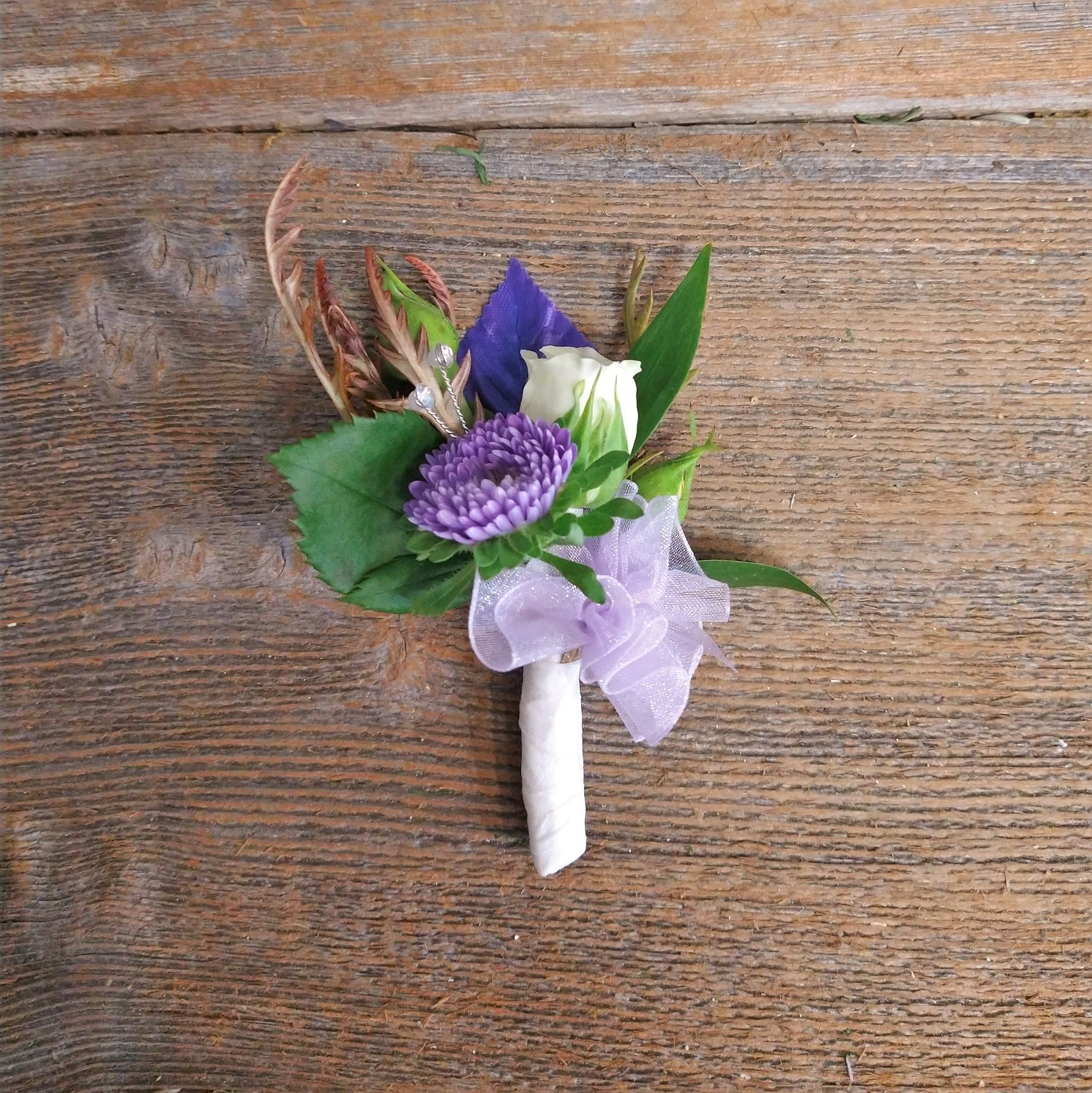 Mixed Flower Boutonniere Mixed Flower Boutonniere - It's boutonniere season. Order from Eureka Florist for a boutonniere that is long-lasting and can be preserved as a keepsake memory. All our boutonniere work is hand-wired; we are the only florist in Humboldt still making hand work in this traditional style! Please include dress/ribbon colors in the special instructions.