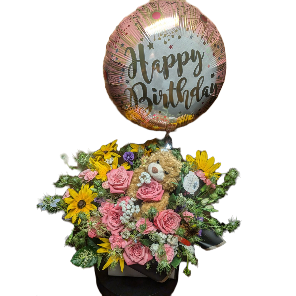 Birthday Bliss Bouquet - Vibrant colors and a touch of whimsy, making it a perfect gift for a memorable birthday celebration. The arrangement features a mix of sunflowers, pink roses, and delicate filler flowers, giving it a lush and cheerful look. Nestled among the blooms is an adorable plush teddy bear, adding a soft, playful element, while a &quot;Happy Birthday&quot; balloon floats above, completing the festive vibe.  Ideal for expressing heartfelt birthday wishes, this bouquet is sure to bring joy and warmth to the recipient’s special day.