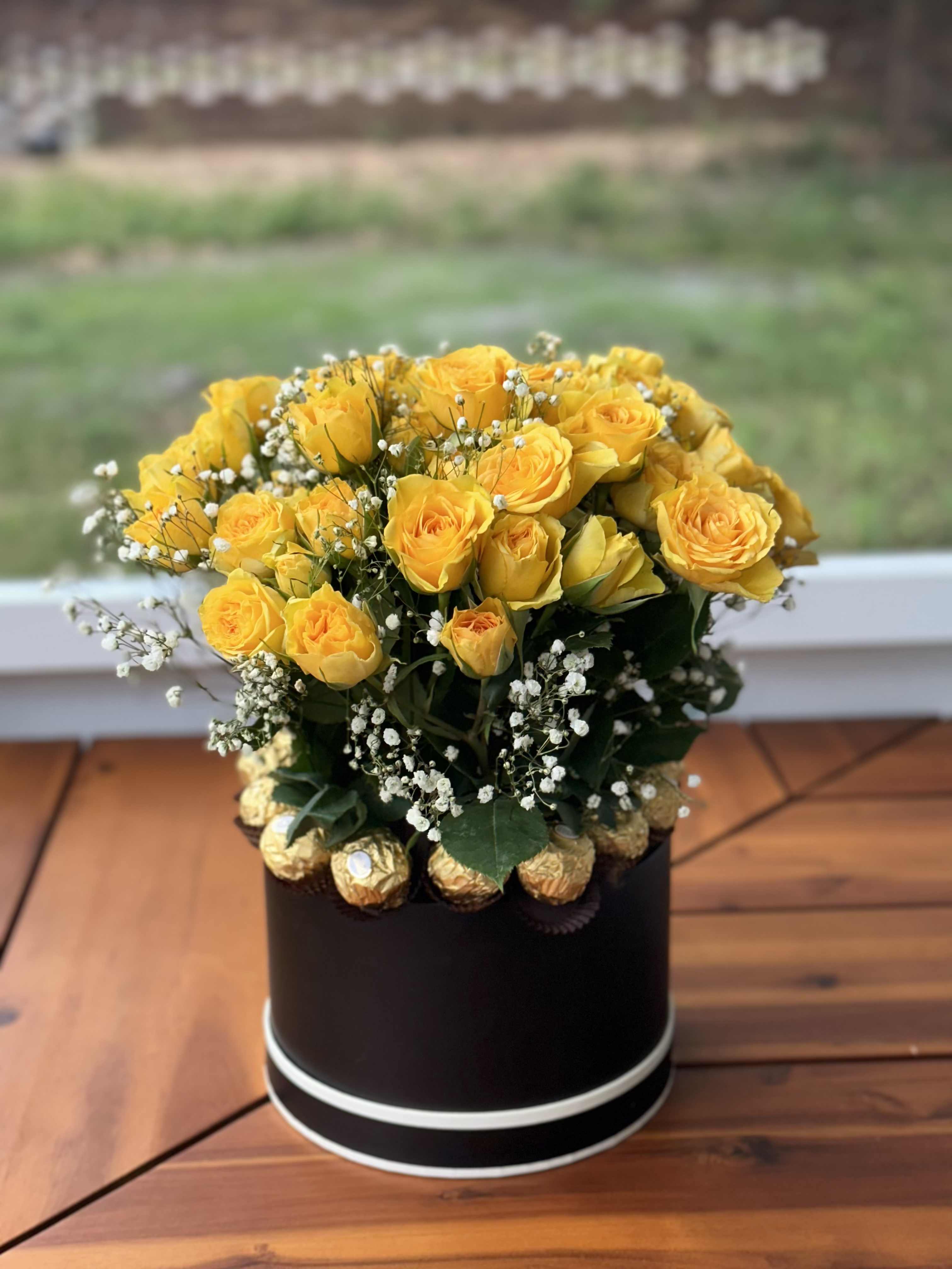 Spray Spray - 24 yellow roses with gypsophila and 12 Ferrero Rocher in a black box.