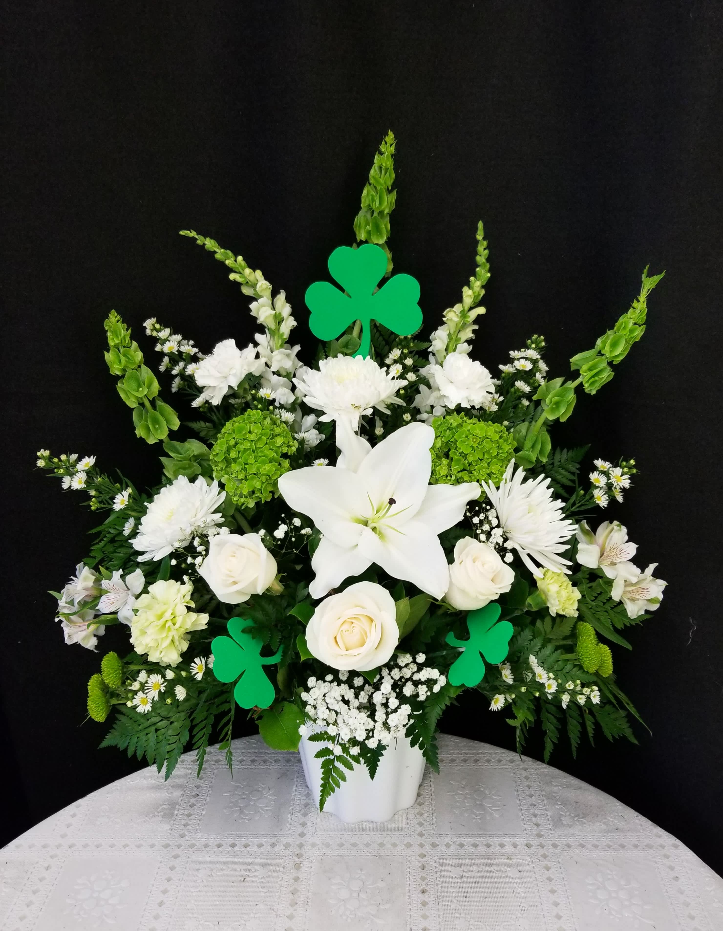 Shamrock Sympathy Basket - The perfect tribute piece for a shamrock-lover. Features green and white flowers including roses and Bells of Ireland.