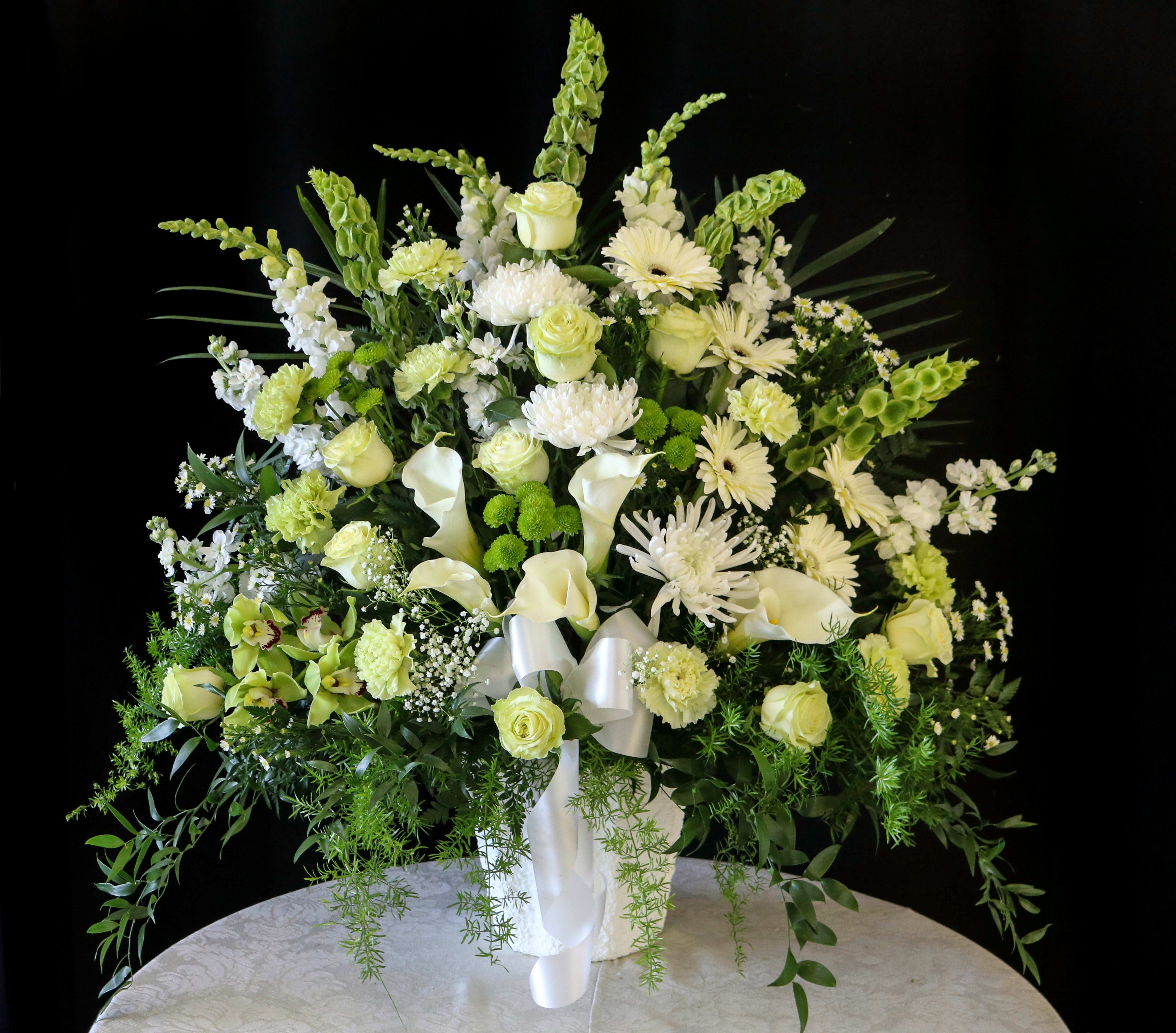 Green Majesty Basket Green Majesty Basket - A basket of subtle extravagance showcasing pastel and vibrant green flowers complemented by peaceful white blooms.