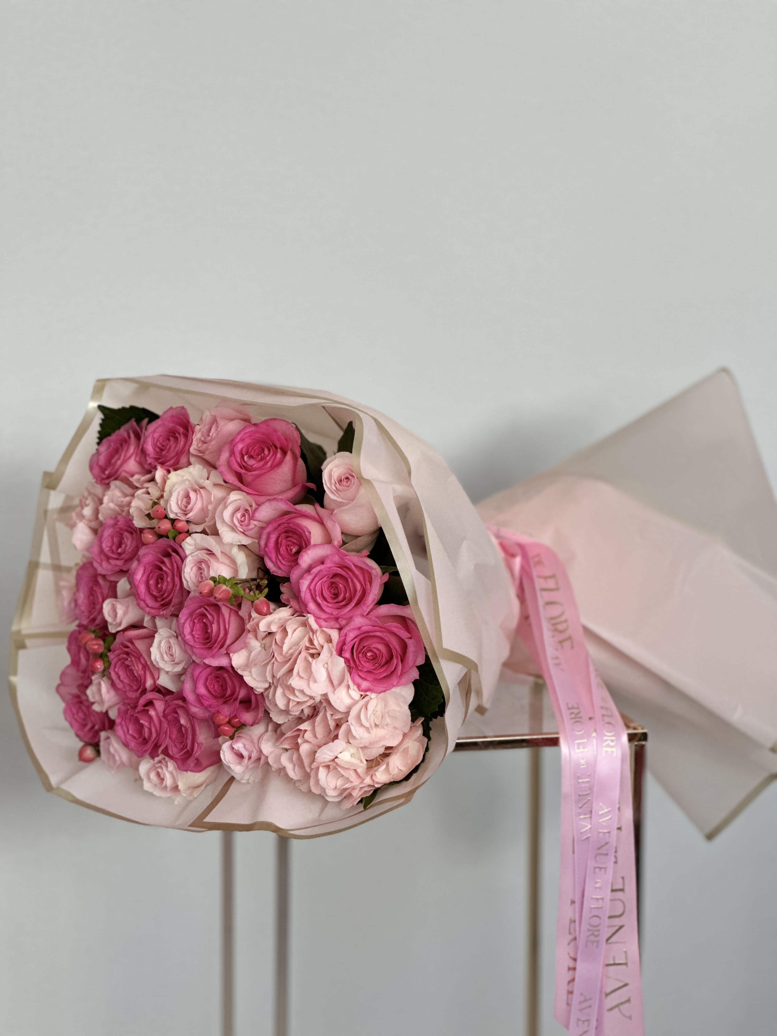 Pink Bloom Bouquet - A bouquet that embodies the essence of romance and elegance, with each bloom carefully selected to evoke feelings of love and admiration. The light pink roses exude softness and grace, while the darker hues add depth and richness to the bouquet. Complementing them all, the pink hydrangea infuses the bouquet with its voluminous blooms and delicate petals, adding a touch of whimsy and charm. 