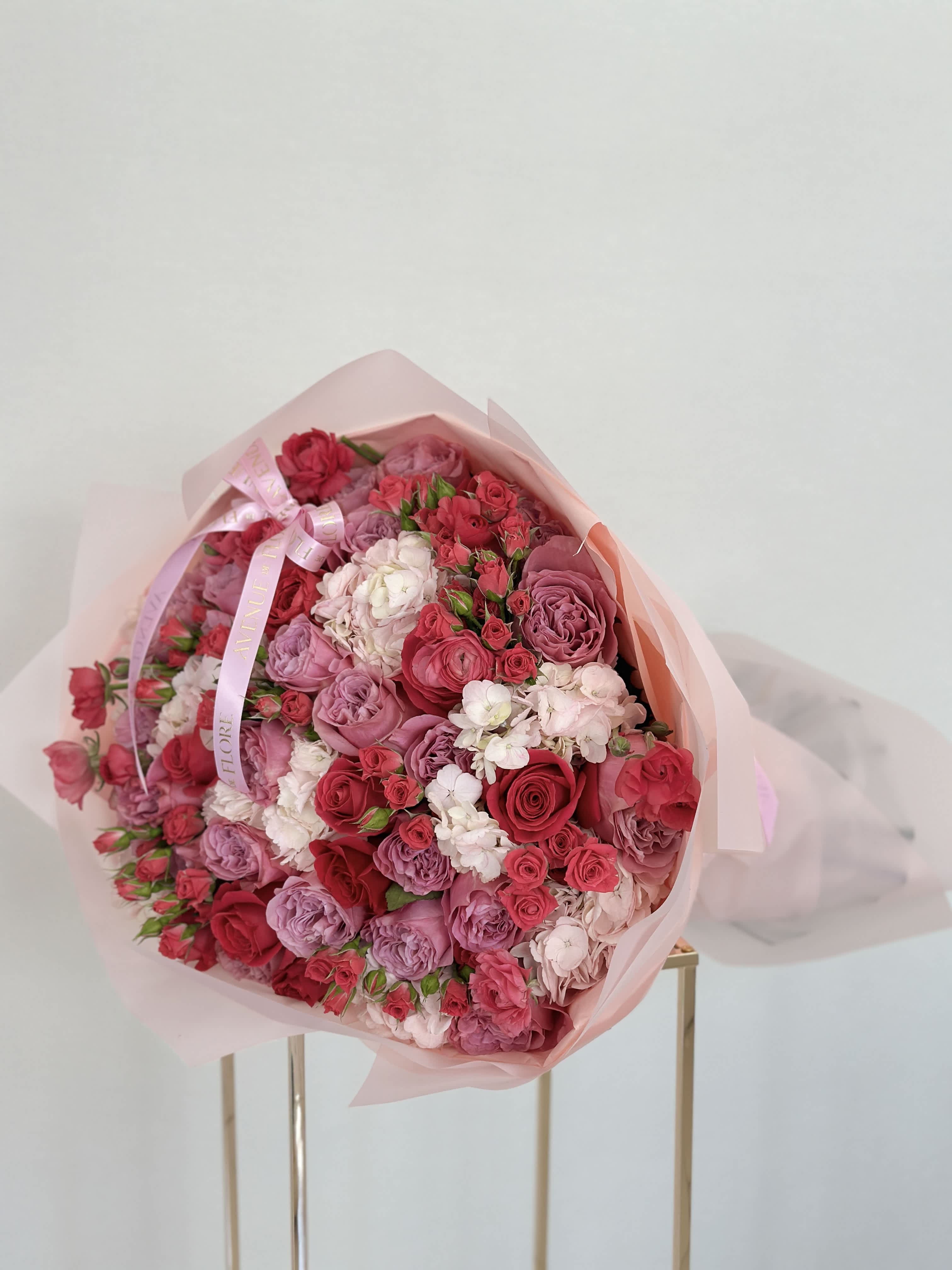 Bloom Paradise - A harmonious blend of delicate lavender garden roses, pink roses, and voluminous pink hydrangeas. The lavender garden roses add a touch of elegance and grace, while the pink roses convey admiration and appreciation. Perfect for celebrating special occasions or expressing love and affection.   