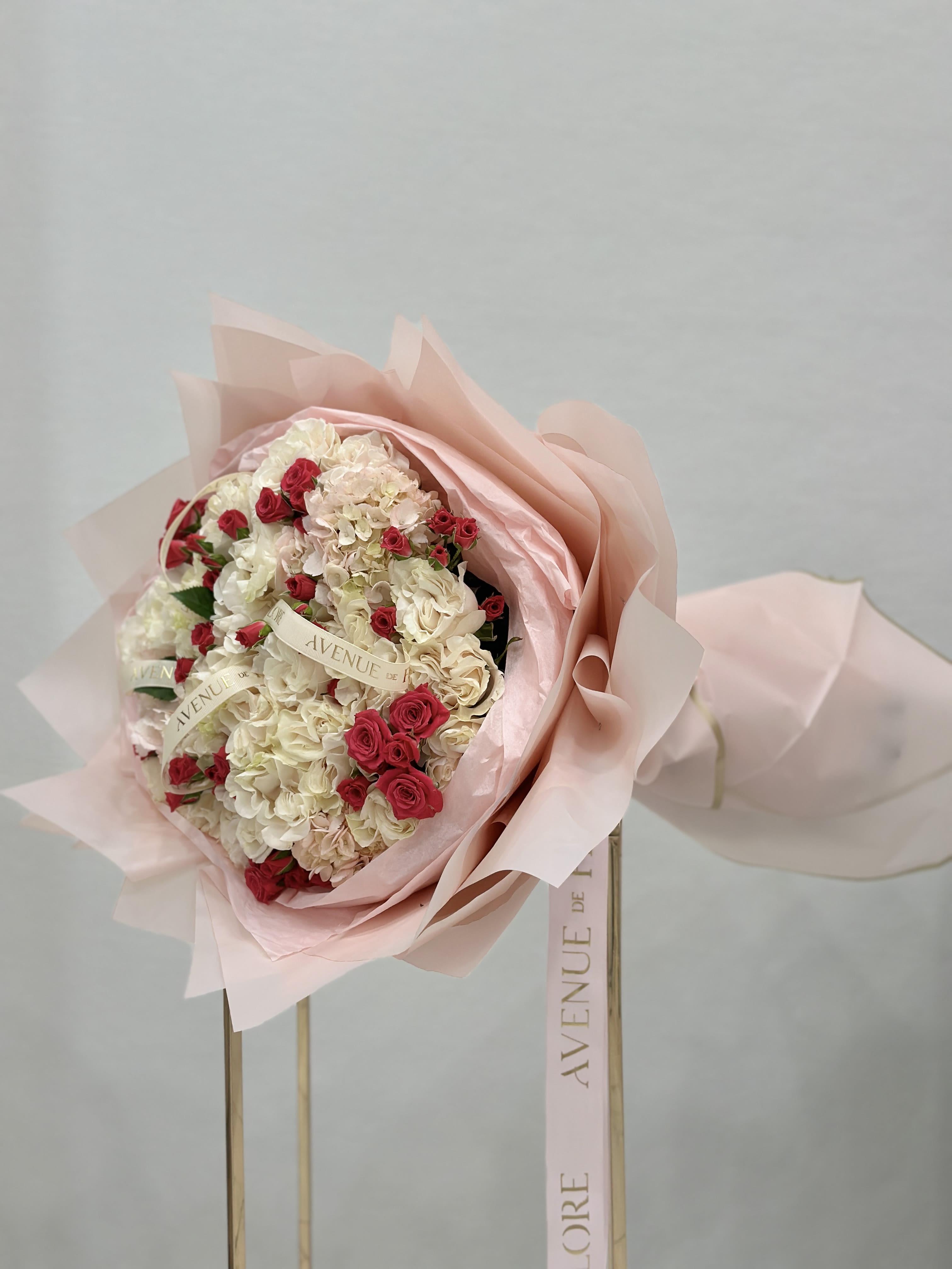 Cloud Nine Garden Rose Bouquet - This vibrant bouquet is a fun, fresh mix of soft and bold! Fluffy hydrangeas bring in that dreamy, cloud-like texture, while the garden roses add a touch of classic elegance. The hot pink spray roses pop with color and energy, making the whole bouquet feel lively and cheerful. It's perfect for adding a little extra brightness and charm to any space or occasion!