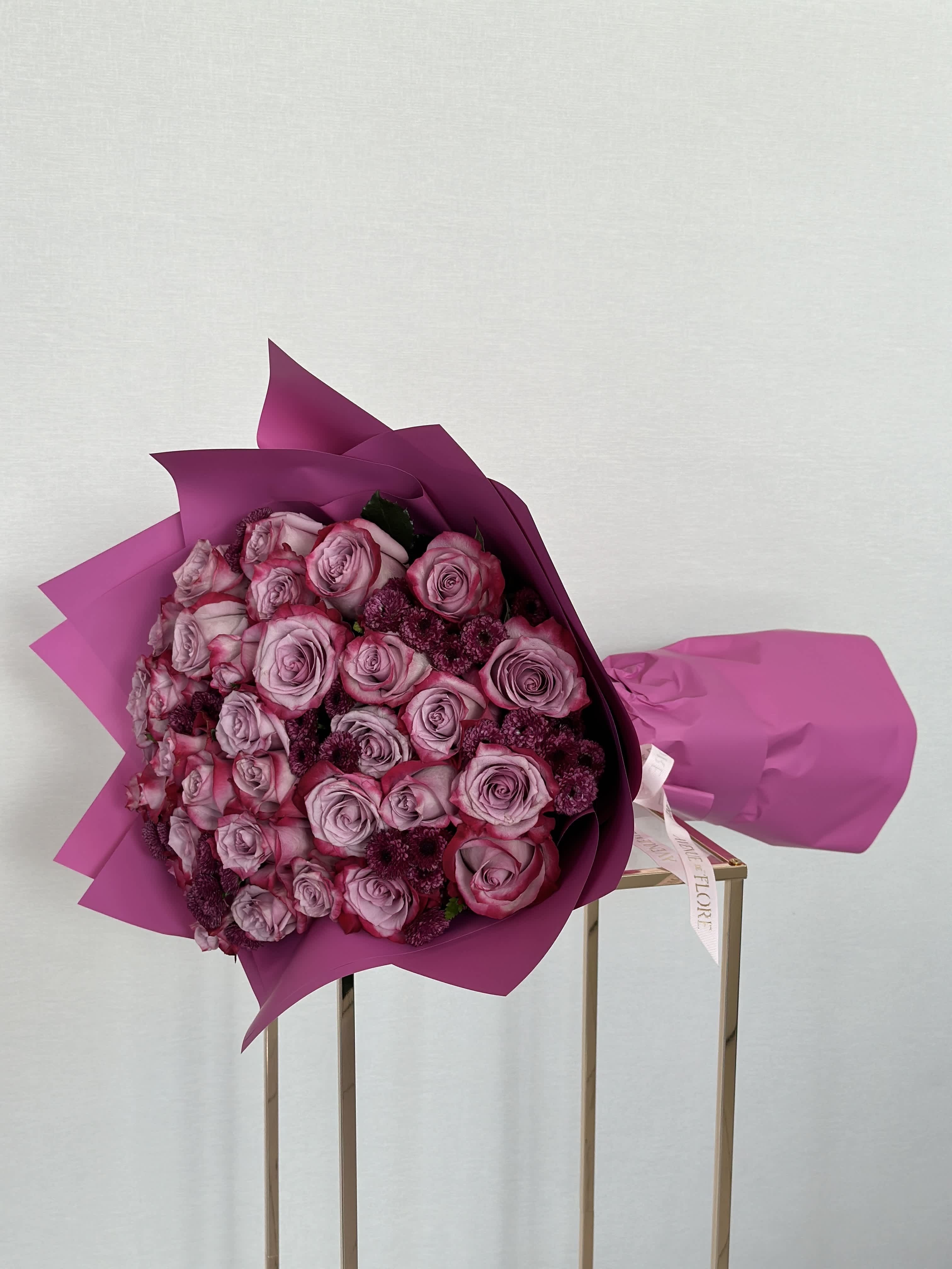 Purple Bliss Bouquet - A captivating bouquet adorned with elegant purple roses and chrysanthemums. A symphony of beauty, weaving together shades of lavender, violet, and amethyst to create a mesmerizing display that captivates the imagination.  