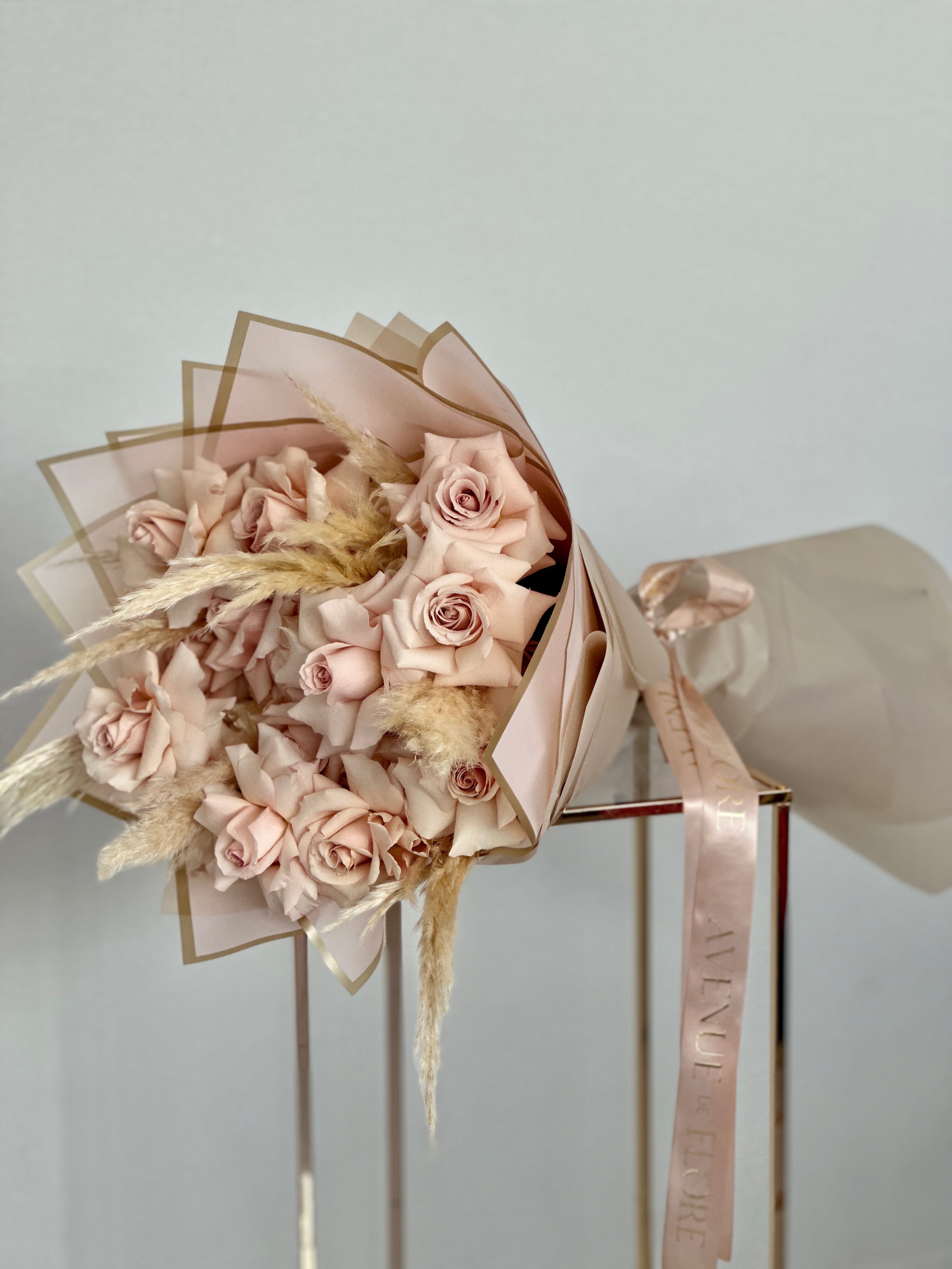 Delicate Neutrality Bouquet - This bouquet features a mesmerizing array of soft beige roses, each one embodying grace and sophistication in its delicate petals. Perfect for those who appreciate the beauty of simplicity, this bouquet is a classic statement of grace and charm.