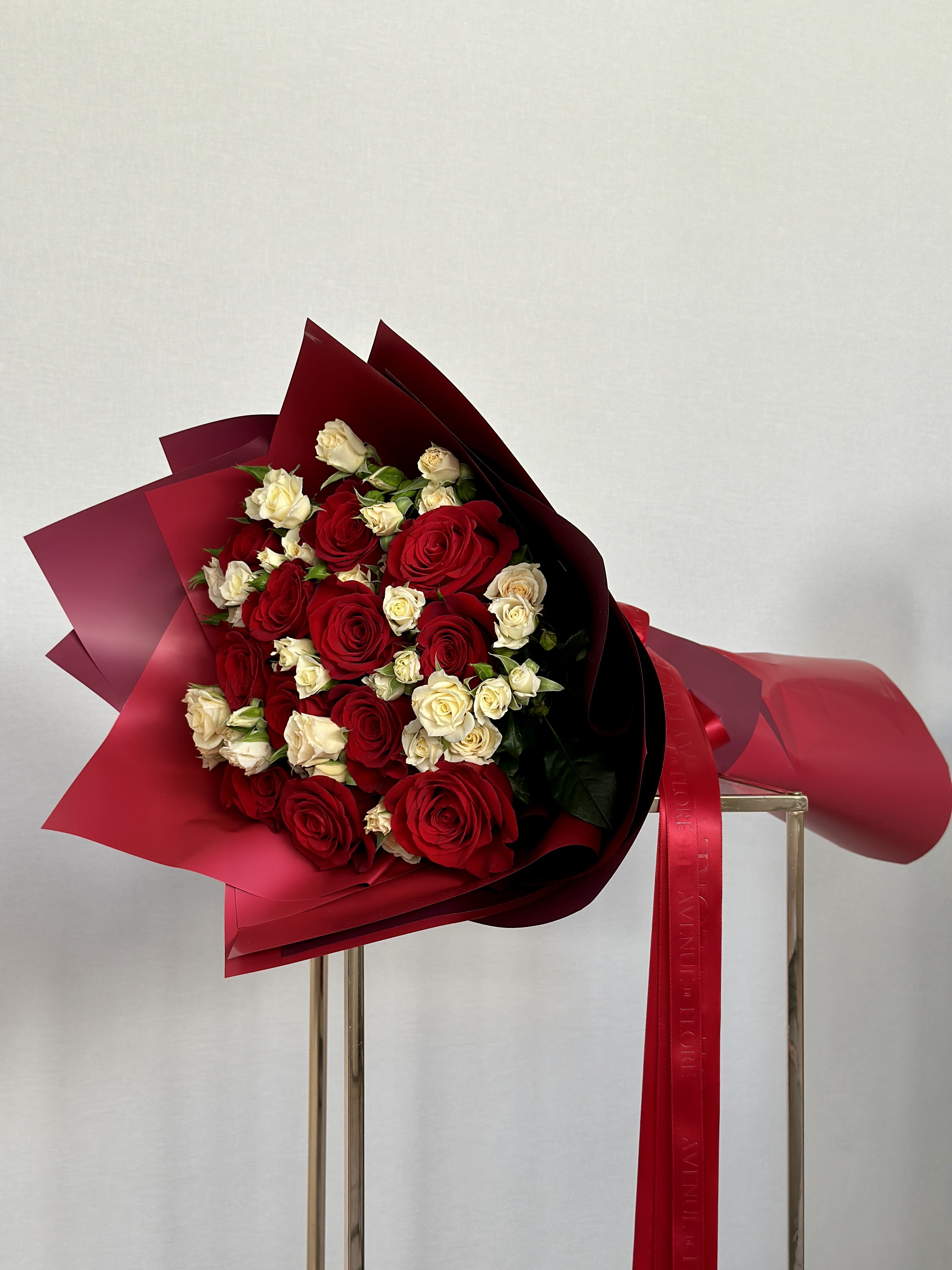 Red Charm Bouquet - This bouquet celebrates the classic beauty and enduring symbol of love—red roses. This stunning arrangement is a declaration of passion, crafted with meticulous attention to detail to convey the depth of emotions that only the richest red hues can express. 