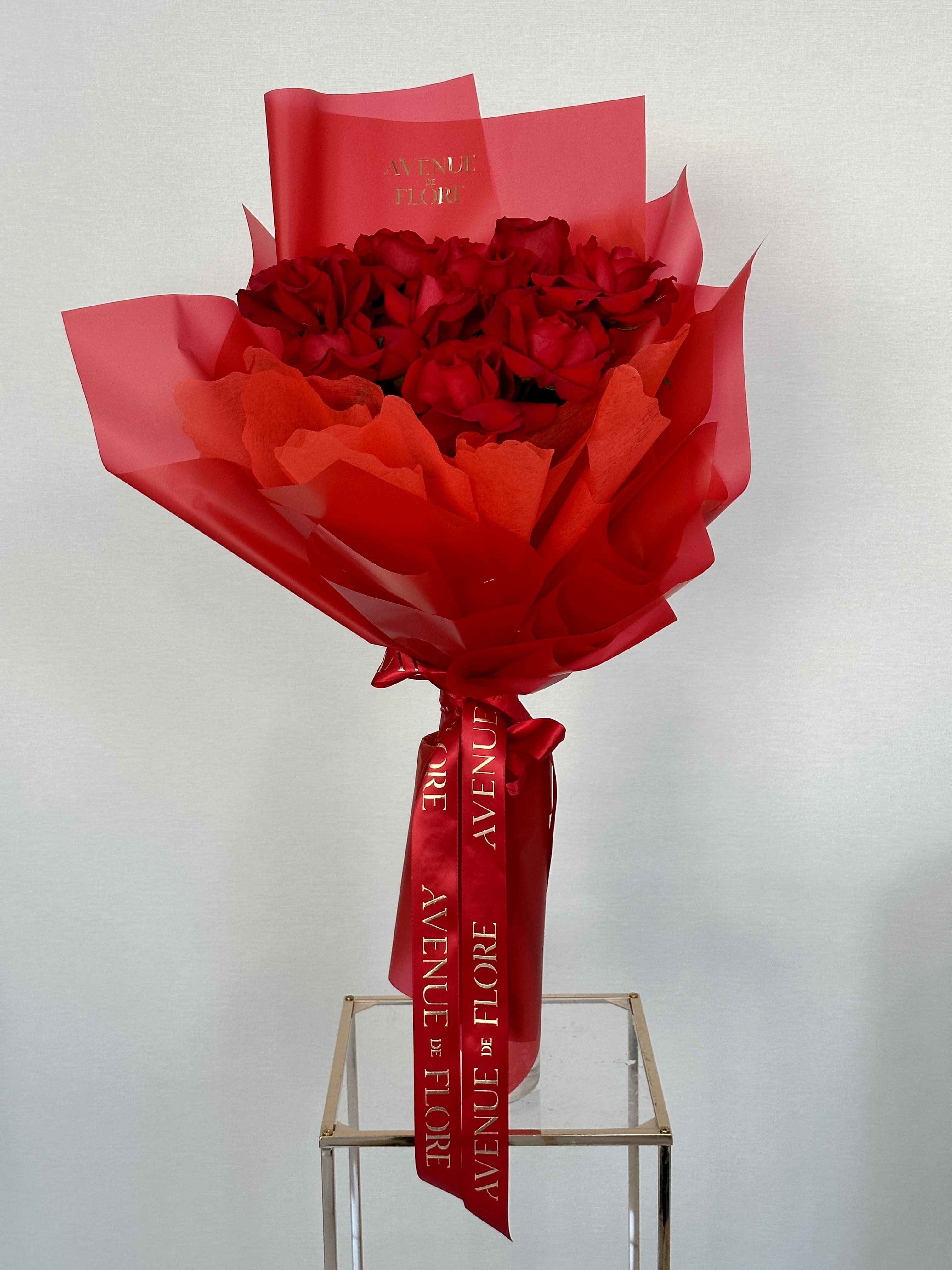Mini Lady in Red Bouquet - This bouquet of red roses is the epitome of grace and beauty, making it a perfect gift for any occasion. The delicate red petals embody a timeless elegance that will enchant anyone who receives it.  Photo features 12 roses. 