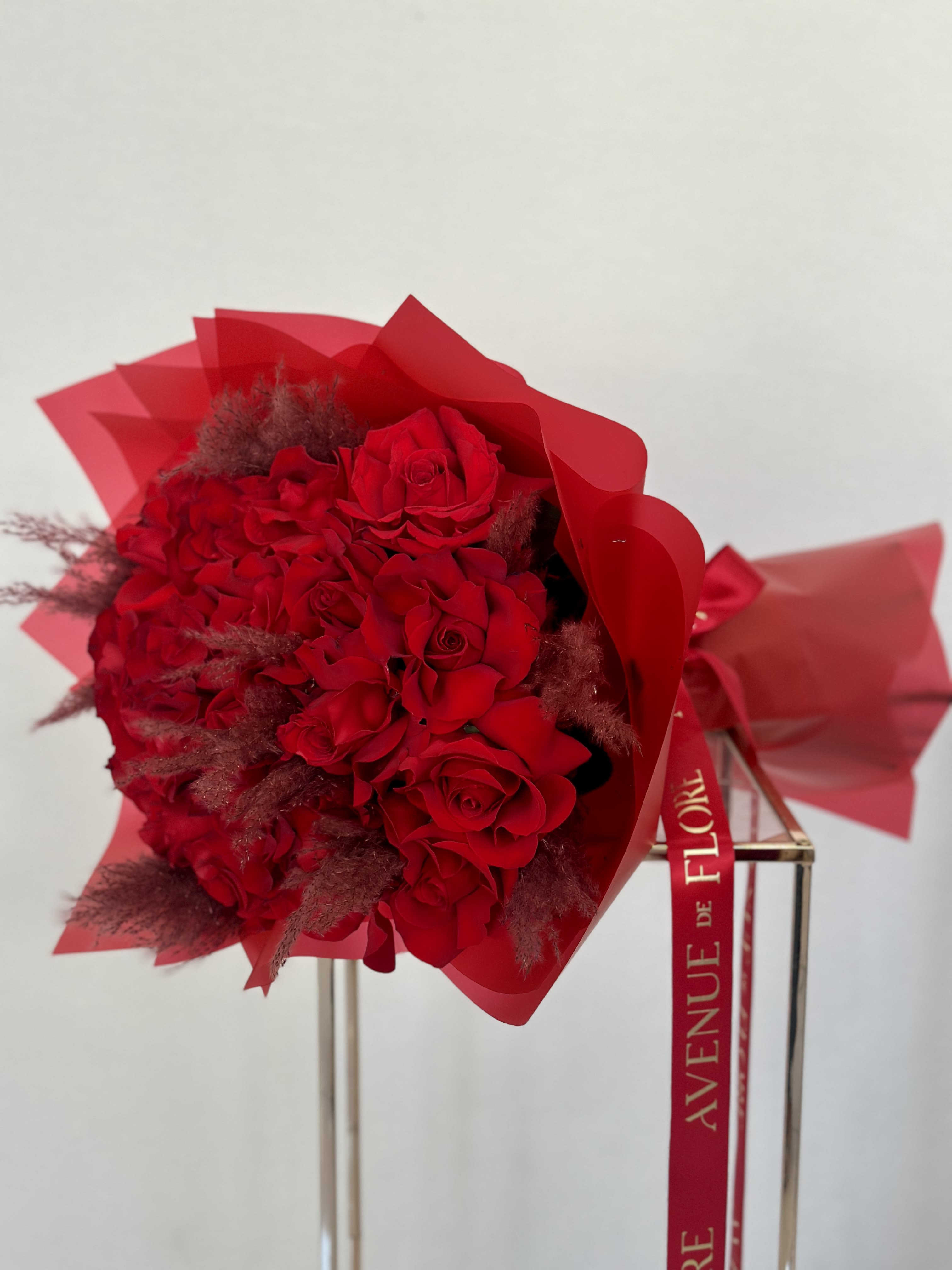 Scarlet Dreams Bouquet - This bouquet of red roses is the epitome of grace and beauty, making it a perfect gift for any occasion.  The delicate red petals embody a timeless elegance that will enchant anyone who receives it.  