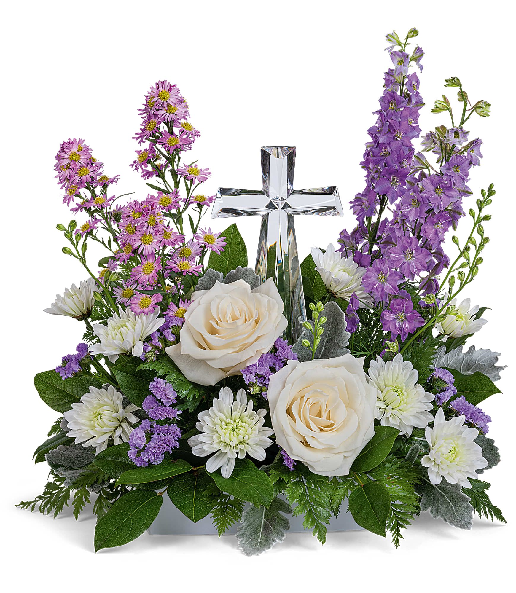 Poised with Love Bouquet - Soft and serene, this artistic array of cream and lavender blooms around a radiant crystal cross keepsake is a heartfelt expression of love.  This beautiful piece includes crème roses, lavender larkspur, lavender montecasino asters, white cushion spray chrysanthemums, lavender sinuata statice, lemon leaf and dusty miller. Delivered with Teleflora's Small Crystal Cross. Approximately 16&quot; W x 16&quot; H 