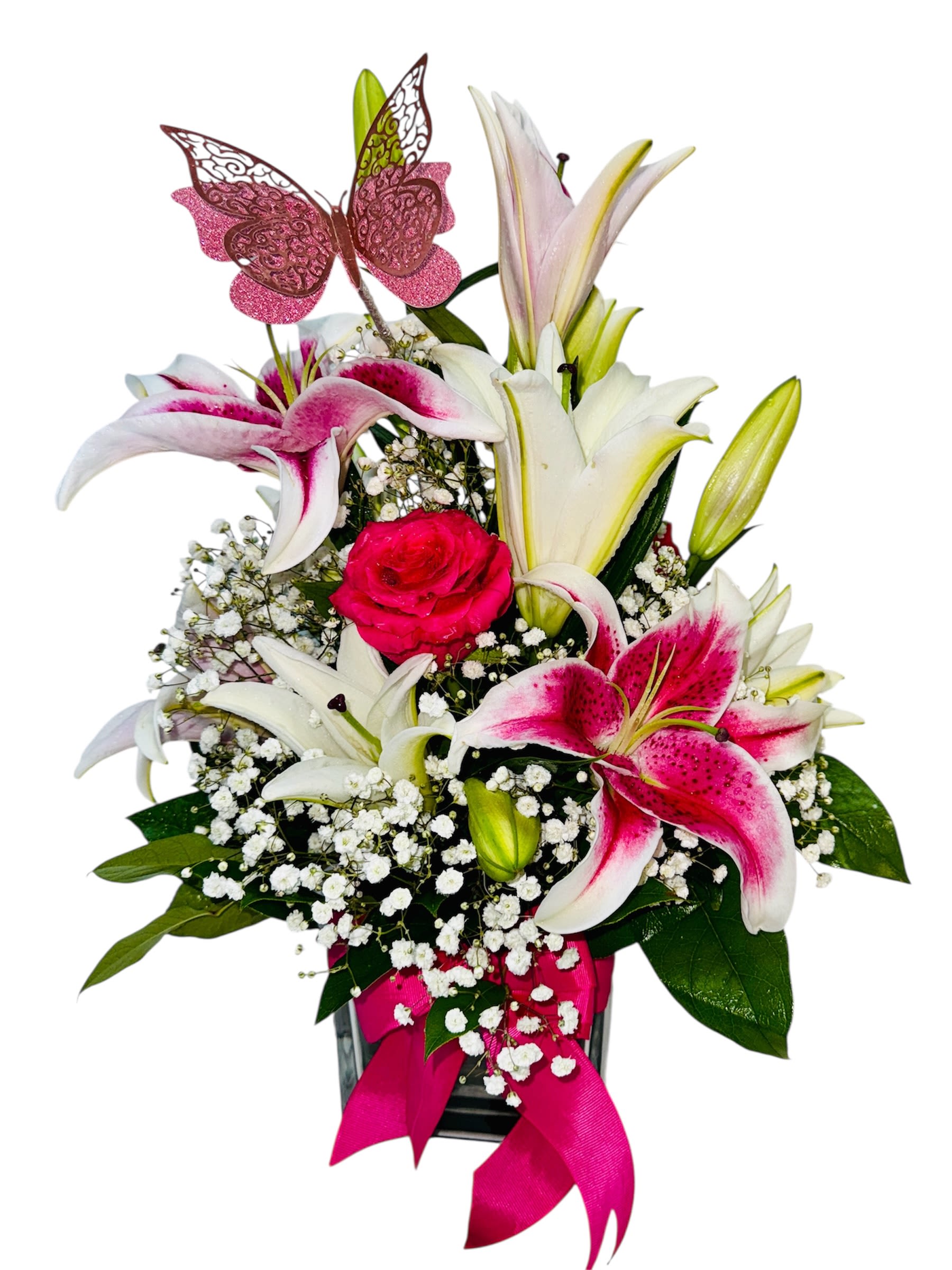 Fluttering Devotion - This sweet and symbolic arrangement combines soft elegance with heartfelt charm. Featuring pink and white lilies, baby's breath, and a striking red rose at the heart, it conveys admiration, purity, and romantic affection. A delicate pink butterfly nestled among the blooms adds a whimsical, personal touch, while the coordinating pink ribbon ties it all together with grace. Presented in a clear glass vase, it’s ideal for expressing love, sympathy, or thoughtful celebration with gentle sophistication.