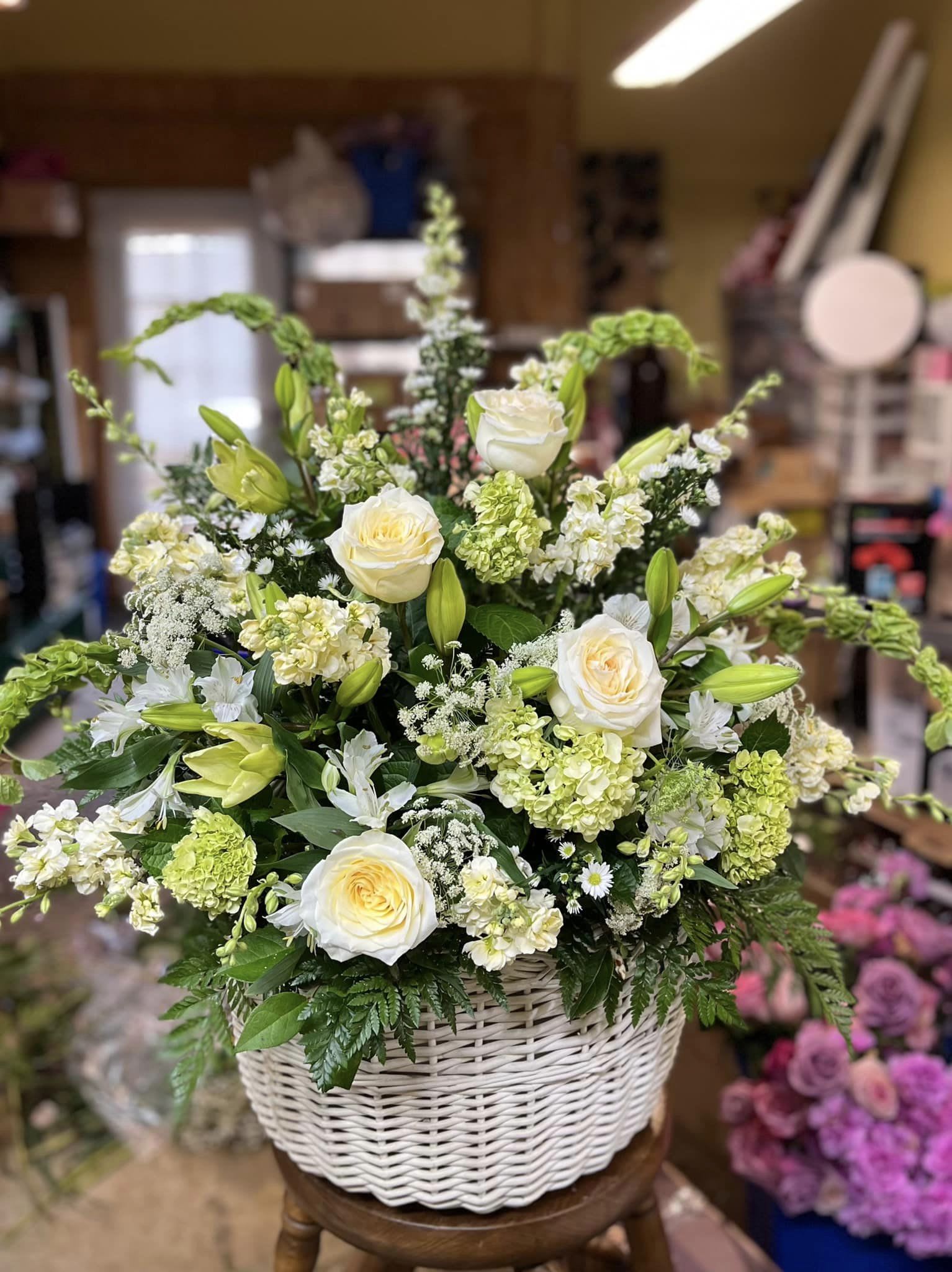 Bold and Beautiful Tribute Bold and Beautiful Tribute - Show is a stunning display of heartfelt sympathy with this basket full of white and green lilies hydrangea, roses etc -THIS Basket itself is no longer - we will do our best to duplicate the arrangement in another container *ARRANGEMENT IS ONE-SIDED*