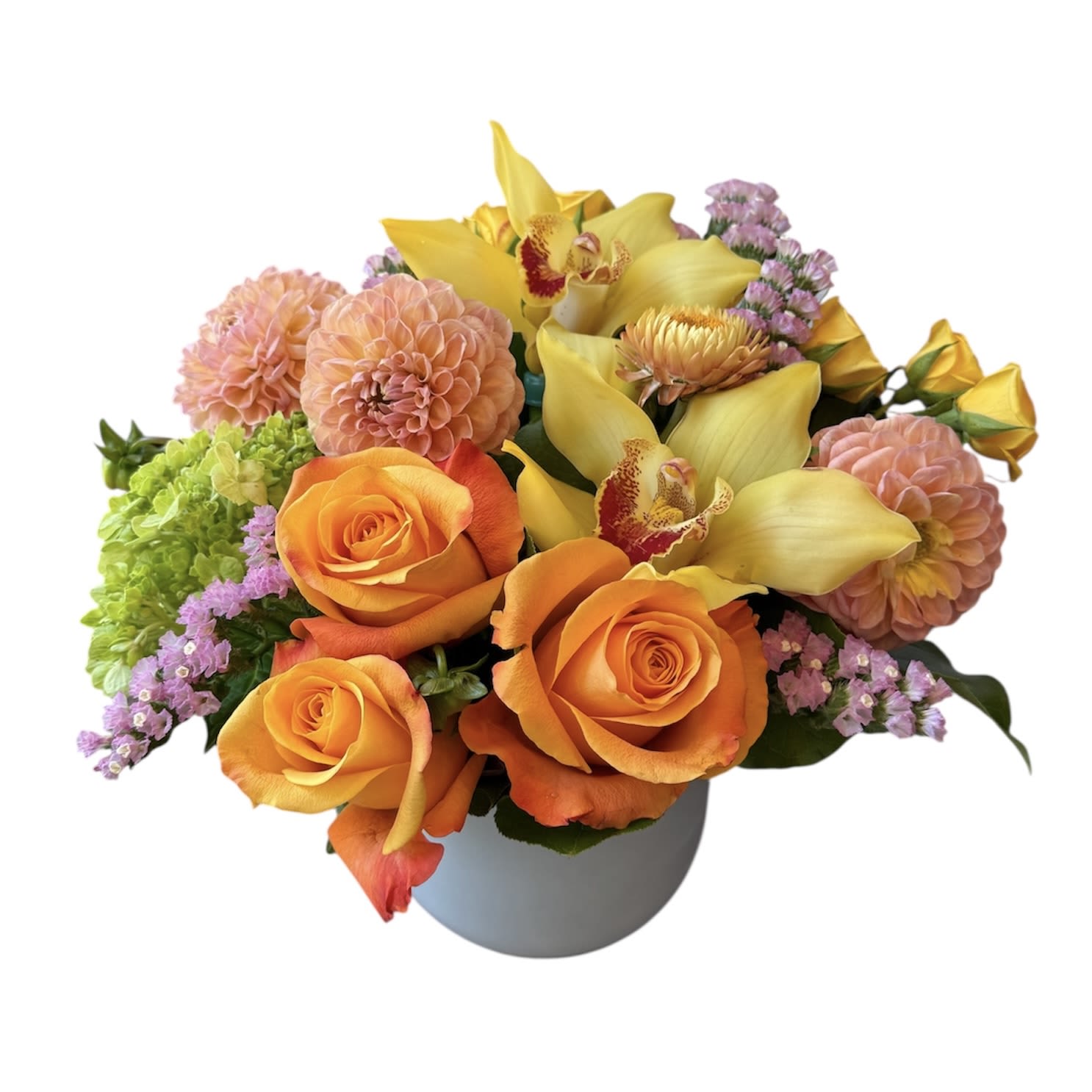 Sweet Citrus  - Orange roses, peach dahlias, yellow orchid, yellow spray rose, green hydrangea and statice designed in white glass vase as shown in photo.