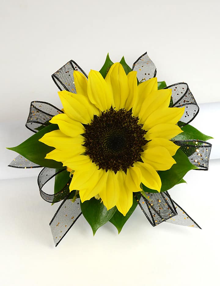 Sunshine Wrist Corsage - This is a fun and simple corsage that is perfect for any occasion. (Ribbon color is chosen based on dress color)   When ordering this corsage, please add the dress color and age of girl in the special instructions.