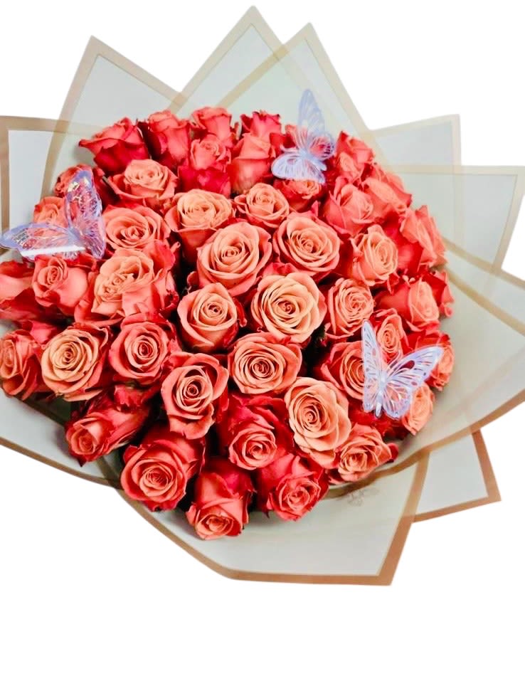 Whispers in Bloom  - This lush bouquet of red and pink roses is a radiant expression of affection and admiration, wrapped in a beautifully layered starburst design. The arrangement evokes both delicacy and depth, with its soft gradient of rosy hues speaking of love in gentle tones. Two translucent butterflies perch gracefully atop the blooms, adding whimsy and symbolic meaning—transformation, soulfulness, and fleeting beauty. It’s a poetic gift, perfect for romantic occasions, milestones, or heartfelt gestures meant to linger in memory.
