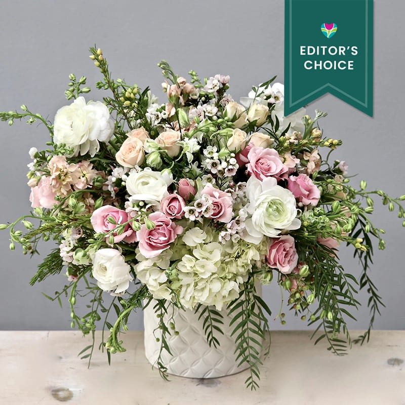 Magic Moment - WeHo Magic Moment - WeHo - Celebrate all the special moments in life with this beautiful arrangement. Standing at approximately 10-12inches tall in the standard size, it includes roses, hydrangeas, and ranunculus in shades of white and pink.