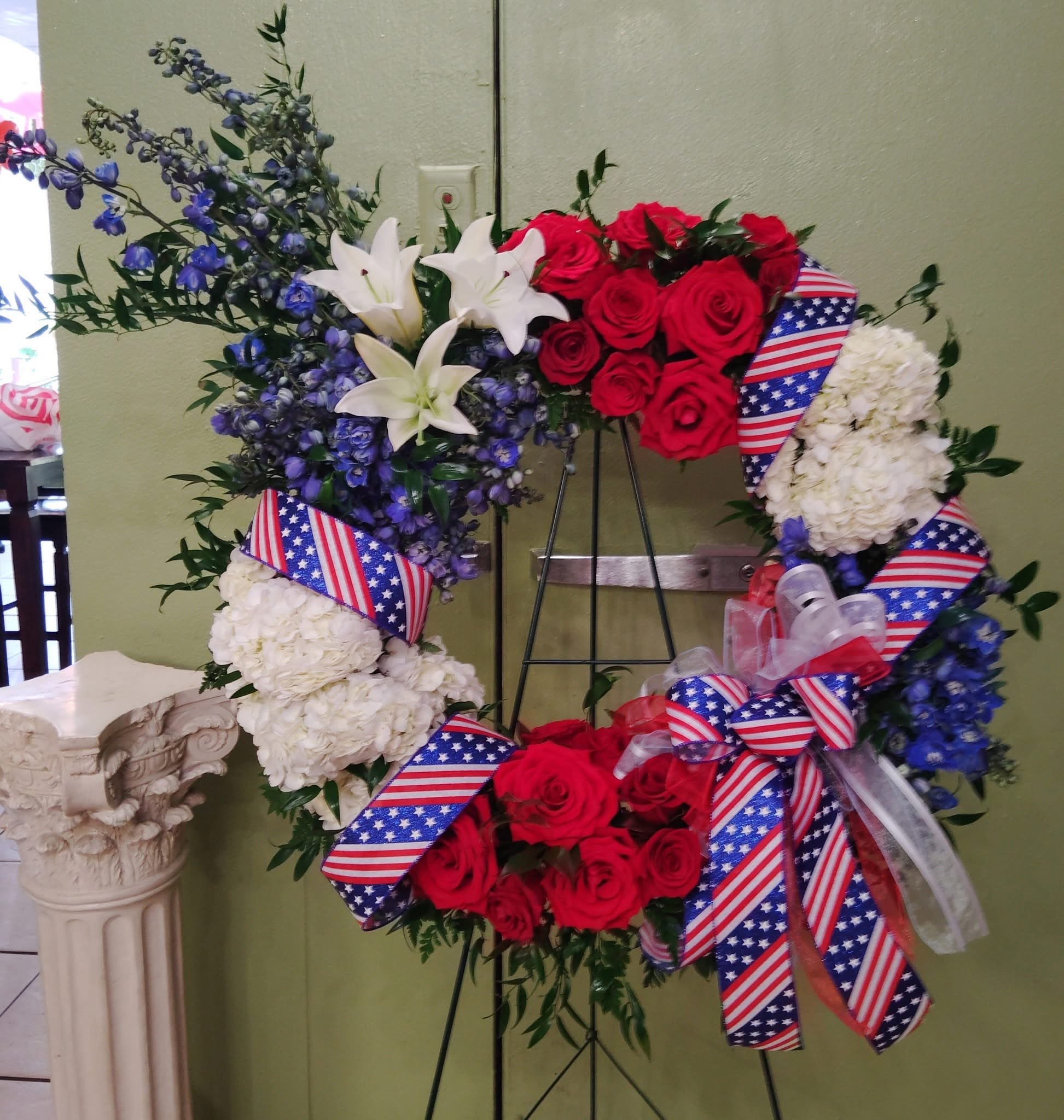 Tribute Wreath - Please Note: The bouquet pictured reflects our original design for this product. While we always try to follow the color palette, we may replace stems to deliver the freshest bouquet possible, and we may sometimes need to use a vase.