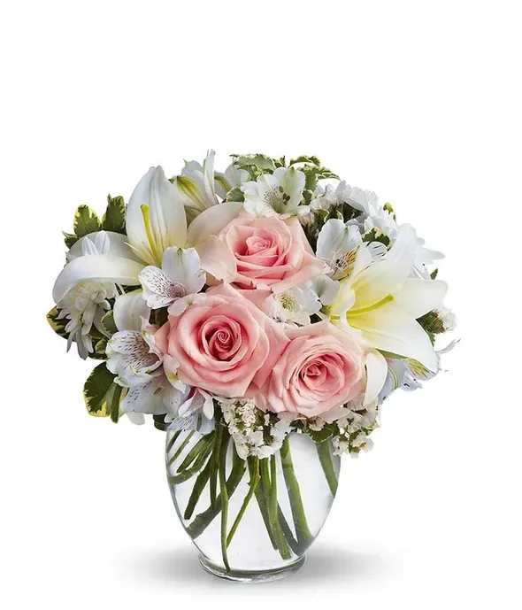 Serenity and Bliss - A simple way to express your love without saying anything, this arrangement is sure to do the trick. The whites and pinks of this bouquet are exquisite, without being overstated. The roses and lilies complement each other, surrounded by other pastel accents in a classic ginger vase. The Serenity and Bliss bouquet is great for any occasion, whether you're celebrating a birthday, anniversary, or just because!