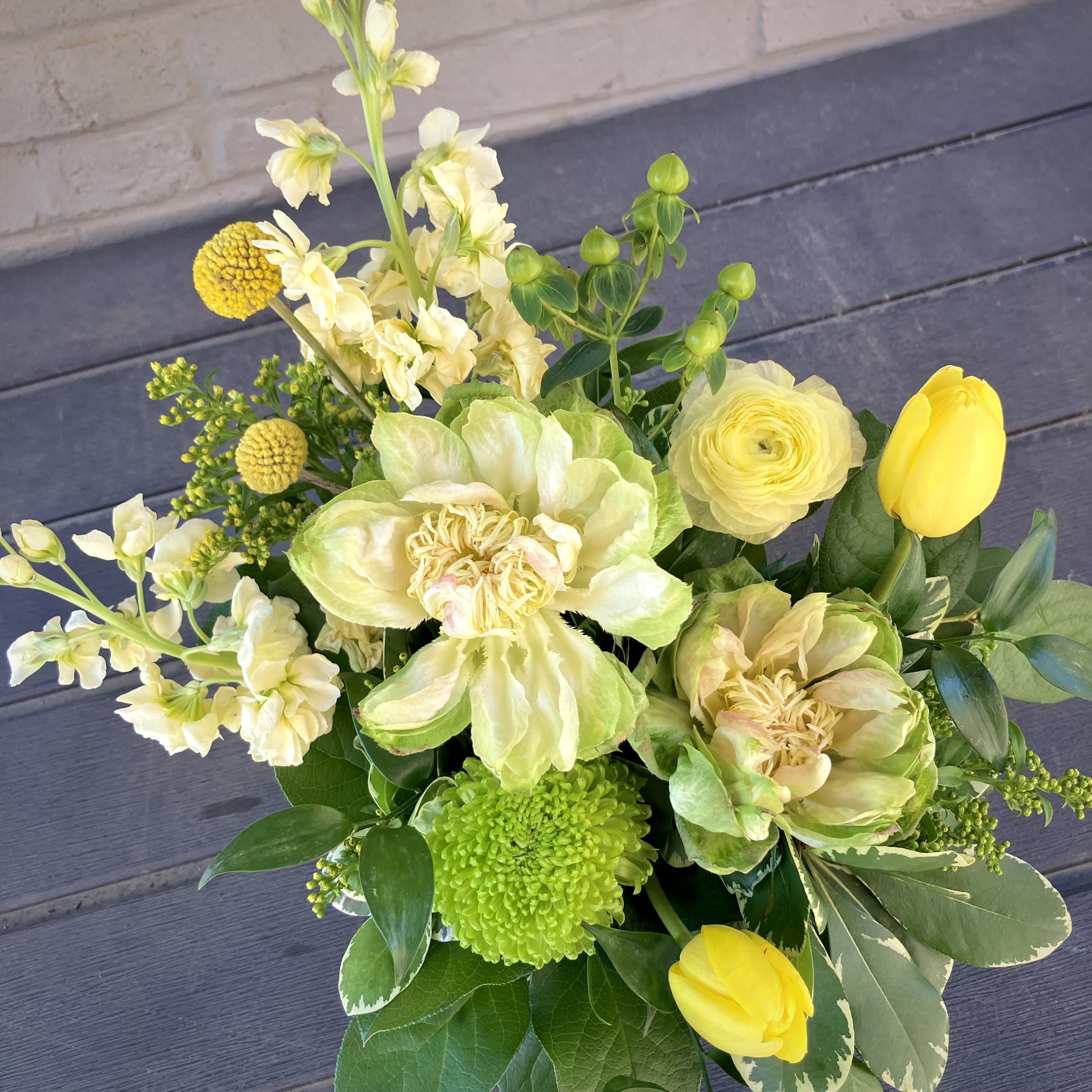 Lemon Lime - This citrusy and summery arrangement is perfect to bring a bright and zesty twist into any home or office space. Including specialty Lotus Roses, elegant Ranunculus, and cheery Crespedia, this beautiful design is sure to spread smiles. Perfect for any home or office space