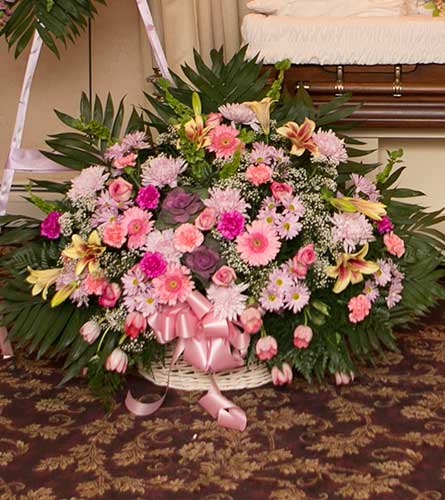 Pink & Lavender Funeral Basket Pink & Lavender Funeral Basket - A lush basket of mixed pink and lavender flowers provide a bright moment and comfort to those who need your support. Approximately 35" high x 28" wide. Bassett Flowers may substitute flowers to ensure quality.