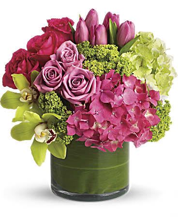 How Sweet it is Bouquet  - Like a girl's getaway to the tropics! Feminine flowers in tropical pastels brighten her day - and her feng shui. She'll love the beautiful serenity and balanced, Zen-like feel of the lush pink and green blooms. A wide array of pink and green flowers are presented in a clear glass cylinder vase that's lined with green ti leaves. Blooms include green hydrangea, pink hydrangea, green cymbidium orchids, hot pink roses, lavender roses, pink tulips and green viburnum. Orientation: All-Around  SUBSTITUTION POLICY – Always deliver the freshest flowers! Please note the bouquet pictured reflects our original design.  If the exact flowers or container in this arrangement are not available, our local florists will create a beautiful bouquet with the freshest available flowers. 