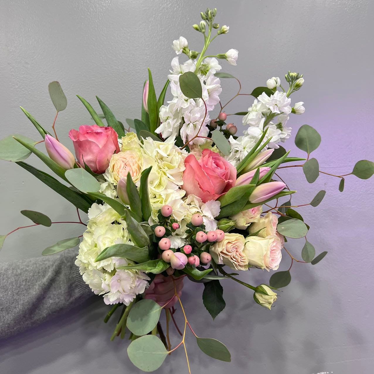 Fall in Love Bouquet - Blush tulips, creamy roses, soft stock, and airy eucalyptus come together in this graceful, garden-style bouquet. “Fall in Love Bouquet” feels like the start of something tender—perfect for fresh starts, quiet mornings, or simply letting someone know you’re thinking of them.  For housewarmings, healing wishes, or gentle celebrations.