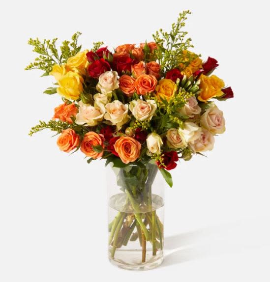 Fall Sunset Bouquet - Layers of golden yellow, burnt orange, crimson, and blush roses unfold like the sky at dusk. “Fall Sunset” is rich, radiant, and brimming with warmth—just like autumn itself. A perfect centerpiece for harvest gatherings, heartfelt thanks, or simply celebrating the season’s quiet beauty.  For golden-hour souls, dinner table hosts, and anyone who deserves to feel warmly remembered.
