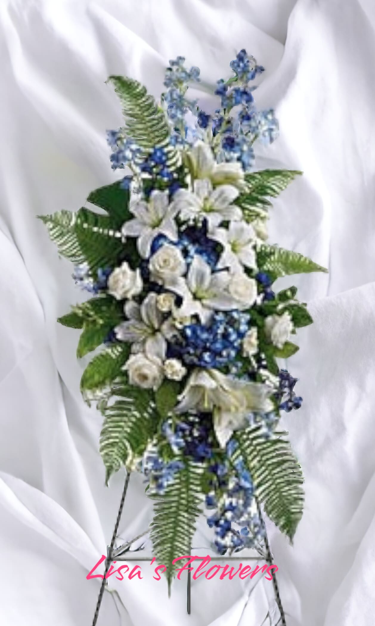 Designer's Choice Sympathy Spray - Standard Designer's Choice Sympathy Spray - Standard - Our best value option. This design is ideal for situations that call for something a little more personalized than the basic standing spray. The standard features more height and volume through the addition of line and accent flowers. Finished arrangement is very generously sized to stand about 6 feet tall. (Displayed on a 60" easel.) Color palettes include, but are not limited to: Neutral: shades of green and/or white Masculine: vibrant colors with lush greenery Feminine: shades of pink, lavender, peach, and/or white, etc Colorful: a vibrant mix of different colors Patriotic: a mix of red, white, and blue Call us to customize your selection.