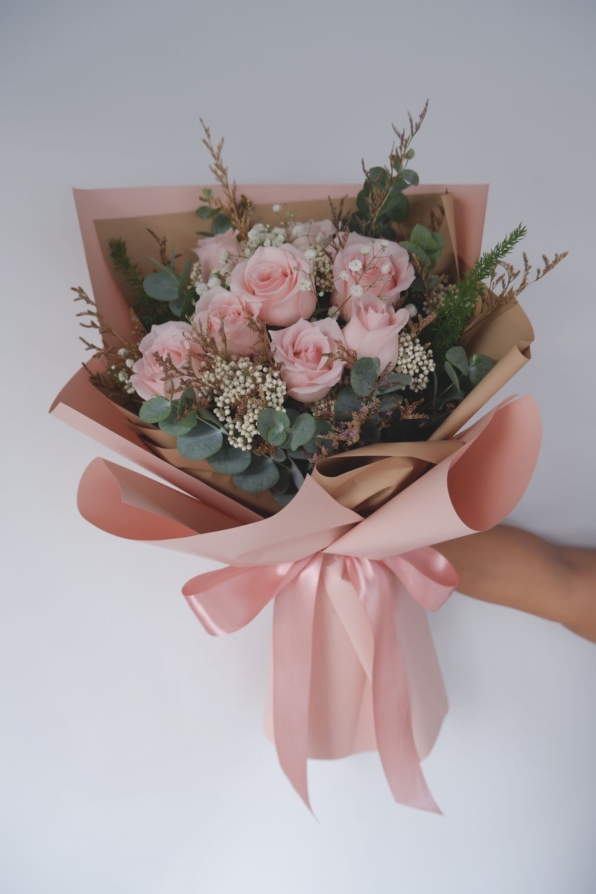 Light Pink Bouquet -  A soft and elegant arrangement in pastel pink tones, paired with fresh greenery that highlights its natural charm. Created to express tenderness, genuine affection, and that sweet touch that makes any moment feel extra special.
