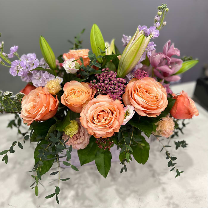 Just Because I Love You Just Because I Love You - A delicate composition of peach garden roses, lavender sprigs, and creamy lilies, this bouquet feels like a whisper across the table. “Just Because I Love You” is made for those quiet gestures—the kind that don’t shout, but linger. Elegant, expressive, and timelessly romantic. Perfect for anniversaries, apologies, or simply reminding them they matter.