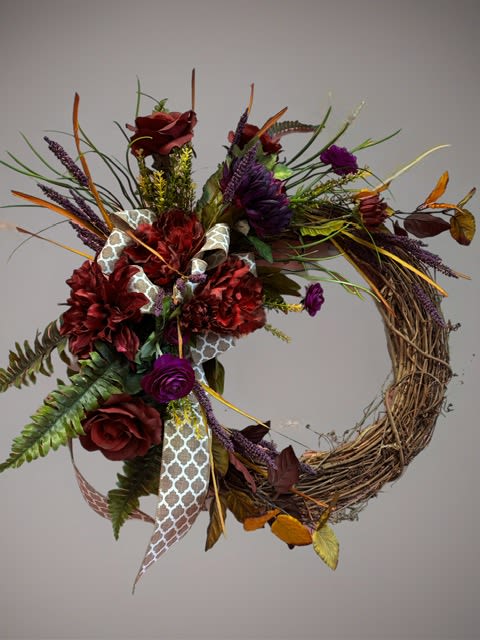 Earth & Elegance Grapevine Wreath Earth & Elegance Grapevine Wreath - Handcrafted Grapevine Wreath -Approx. 18" diameter. Sophisticated, earthy, and rich in texture, "Earth & Elegance" is a stunning handcrafted wreath that brings timeless beauty to any door or wall. Built on a ntural grapevine base, this arrangement features lush greenery, soft grasses, and sprigs of lavender that add depth and gentle movement.