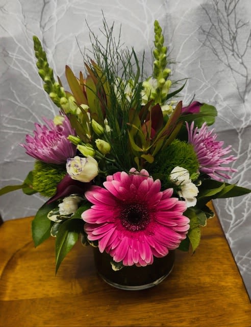 Key West - White, Pink and lavender color palette. Using snapdragon, chrysanthemum, Lisianthus, Dianthus, Italian ruscus, Calla lily, Mini Carnations, Fern and protea 